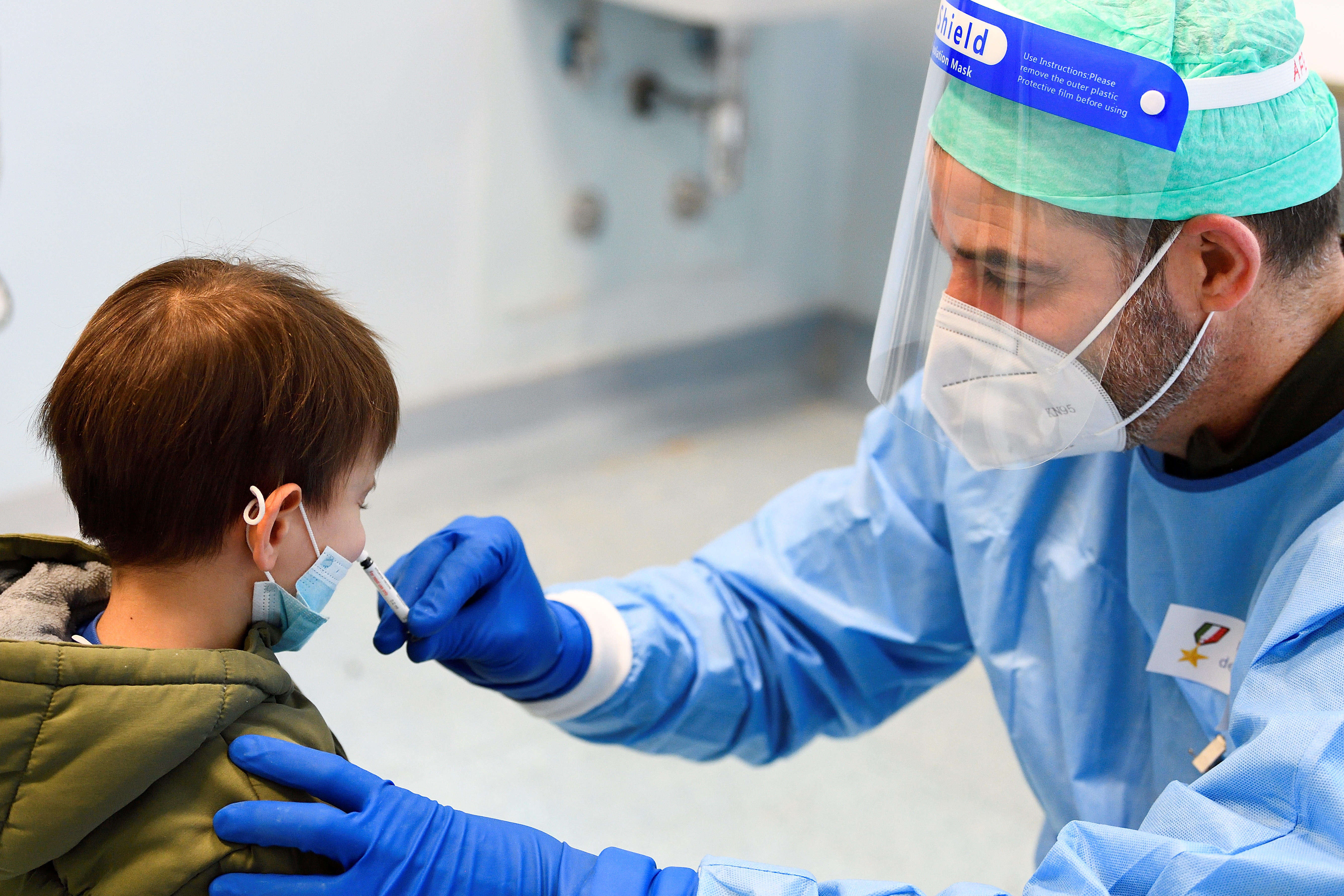 FOTO DE ARCHIVO: Un médico militar en Milán, Italia, administra una vacuna antigripal a un niño para evitar la confusión con los síntomas del COVID-19 el 20 de noviembre de 2020. REUTERS/Flavio Lo Scalzo
