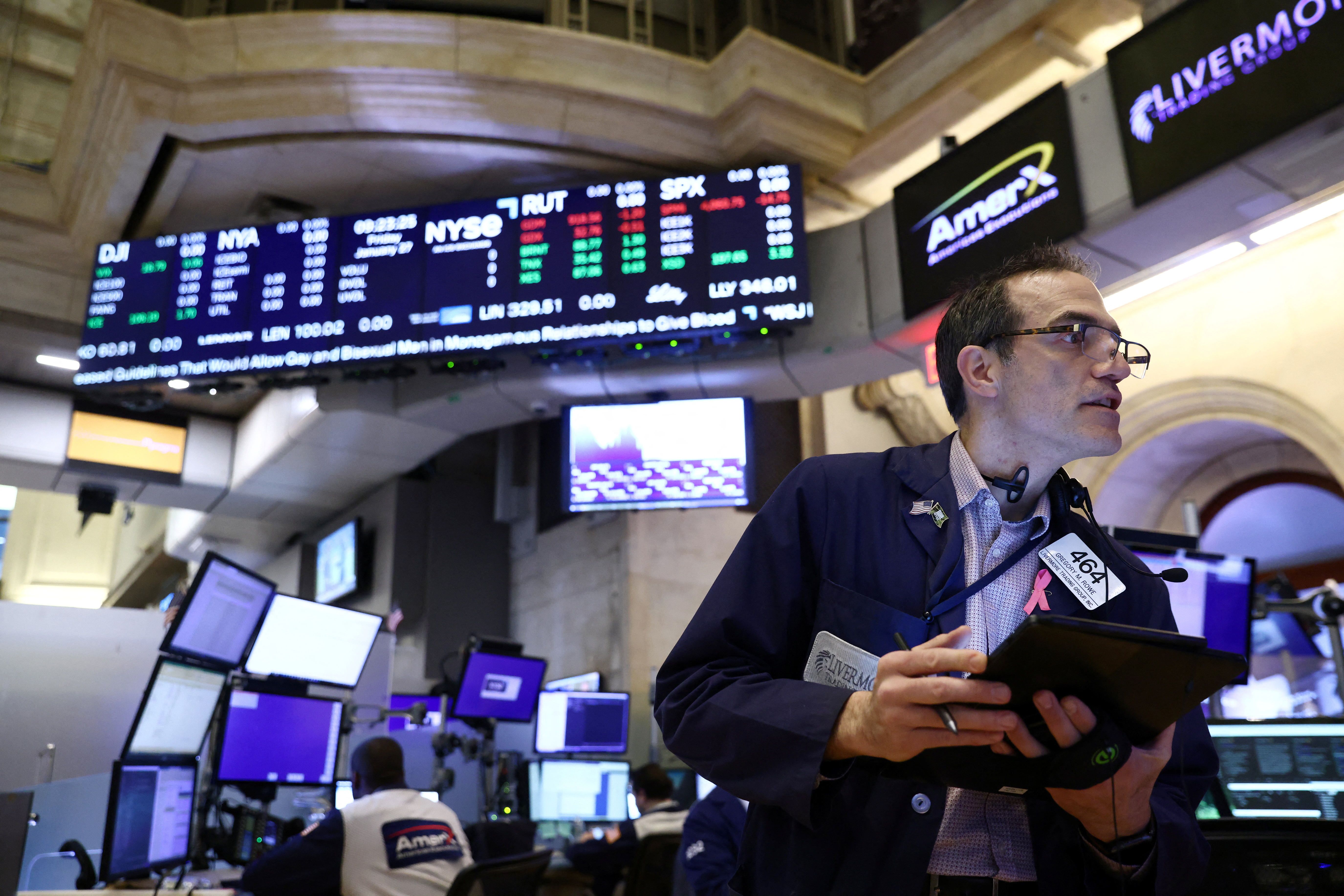 A trader works on the trading floor at the New York Stock Exchange (NYSE) in New York City, U.S., January 27, 2023. REUTERS/Andrew Kelly