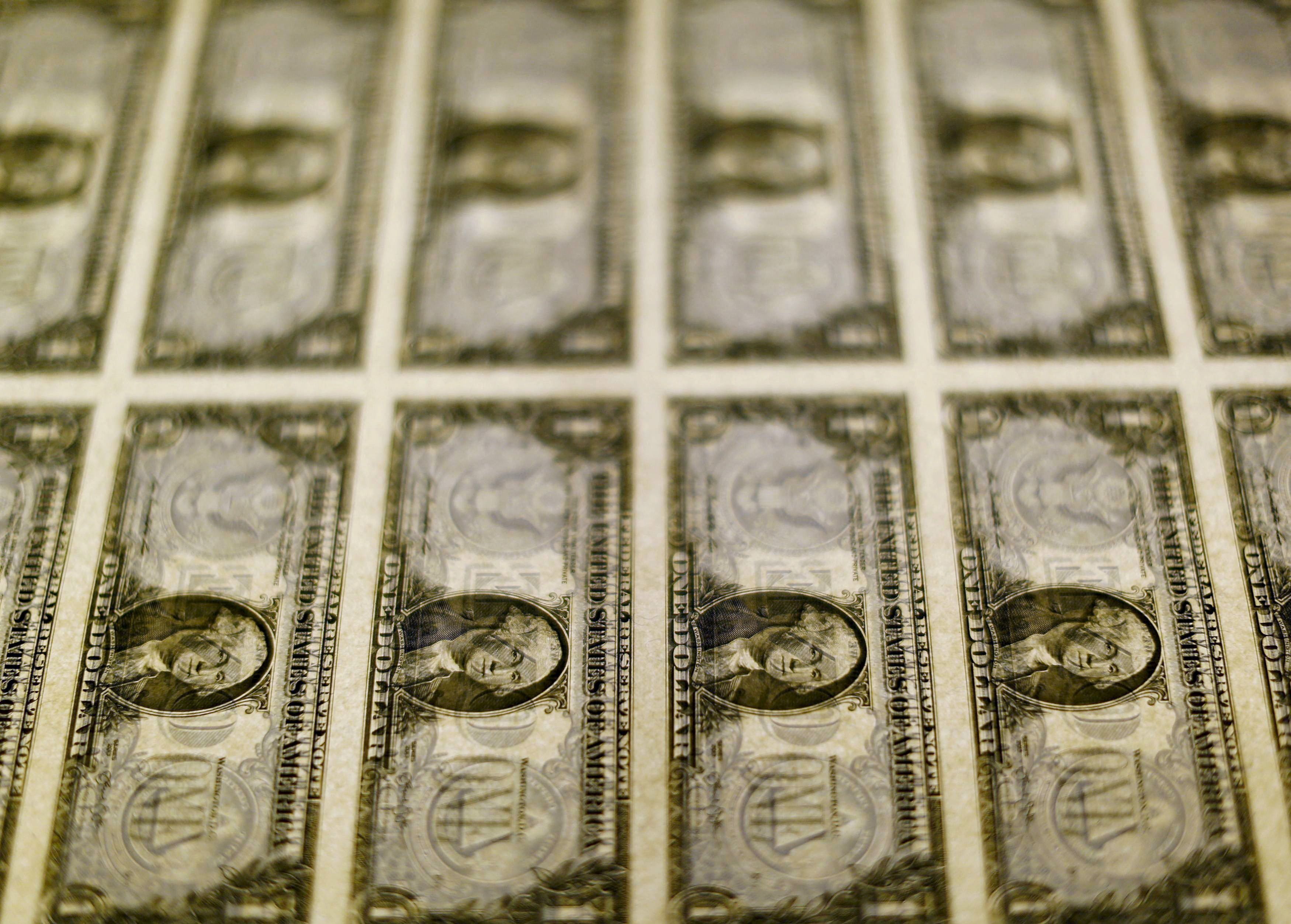 FILE PHOTO: United States one dollar bills are seen on a light table at the Bureau of Engraving and Printing in Washington in this November 14, 2014, file photo. REUTERS/Gary Cameron/File Photo