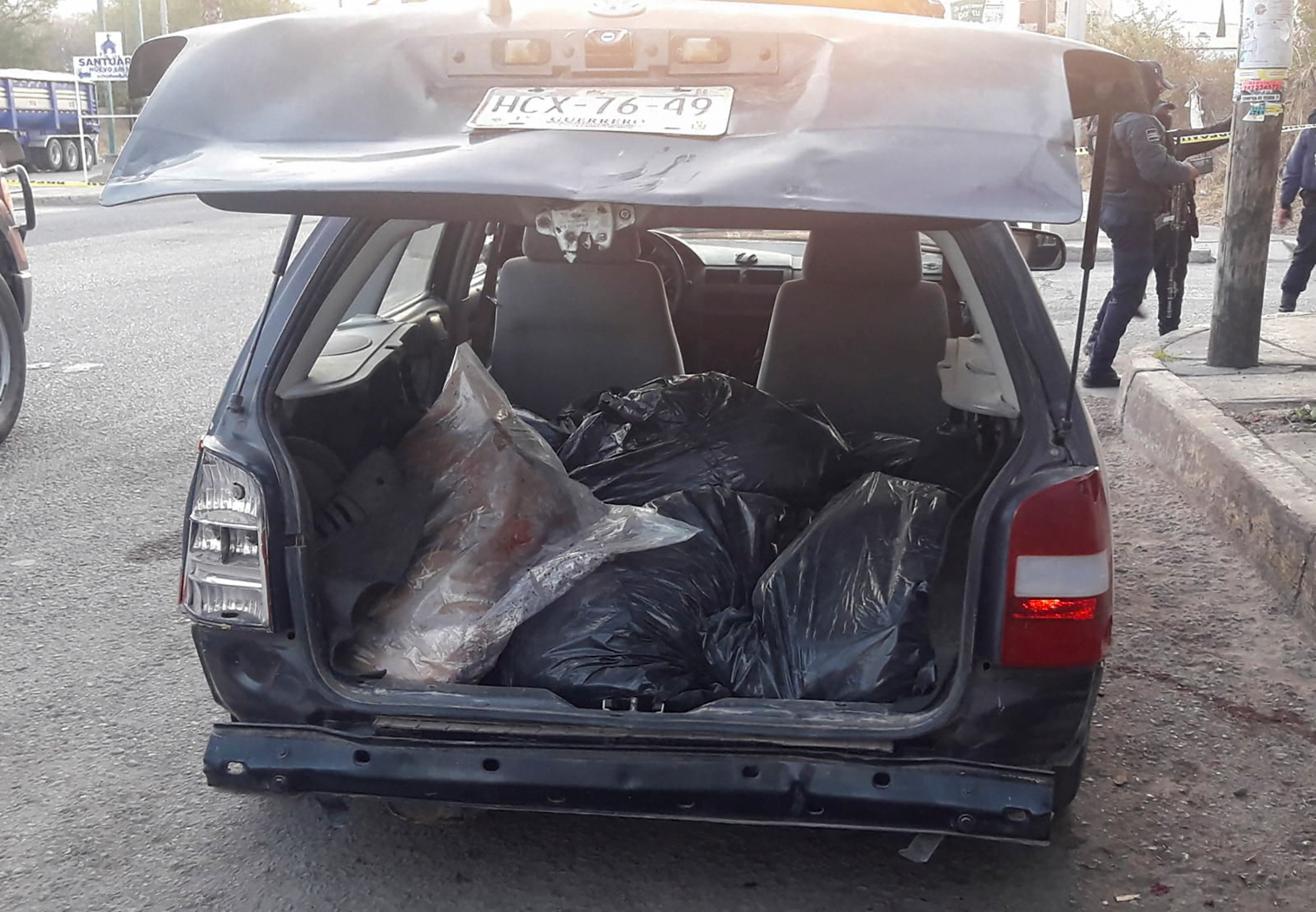  SENSITIVE MATERIAL. THIS IMAGE MAY OFFEND OR DISTURB    Bags containing human remains are stacked inside a car after the severed heads of six men were discovered atop the car, as police secures the crime scene, in Chilapa, Mexico March 31, 2022. REUTERS/Stringer NO RESALES. NO ARCHIVES