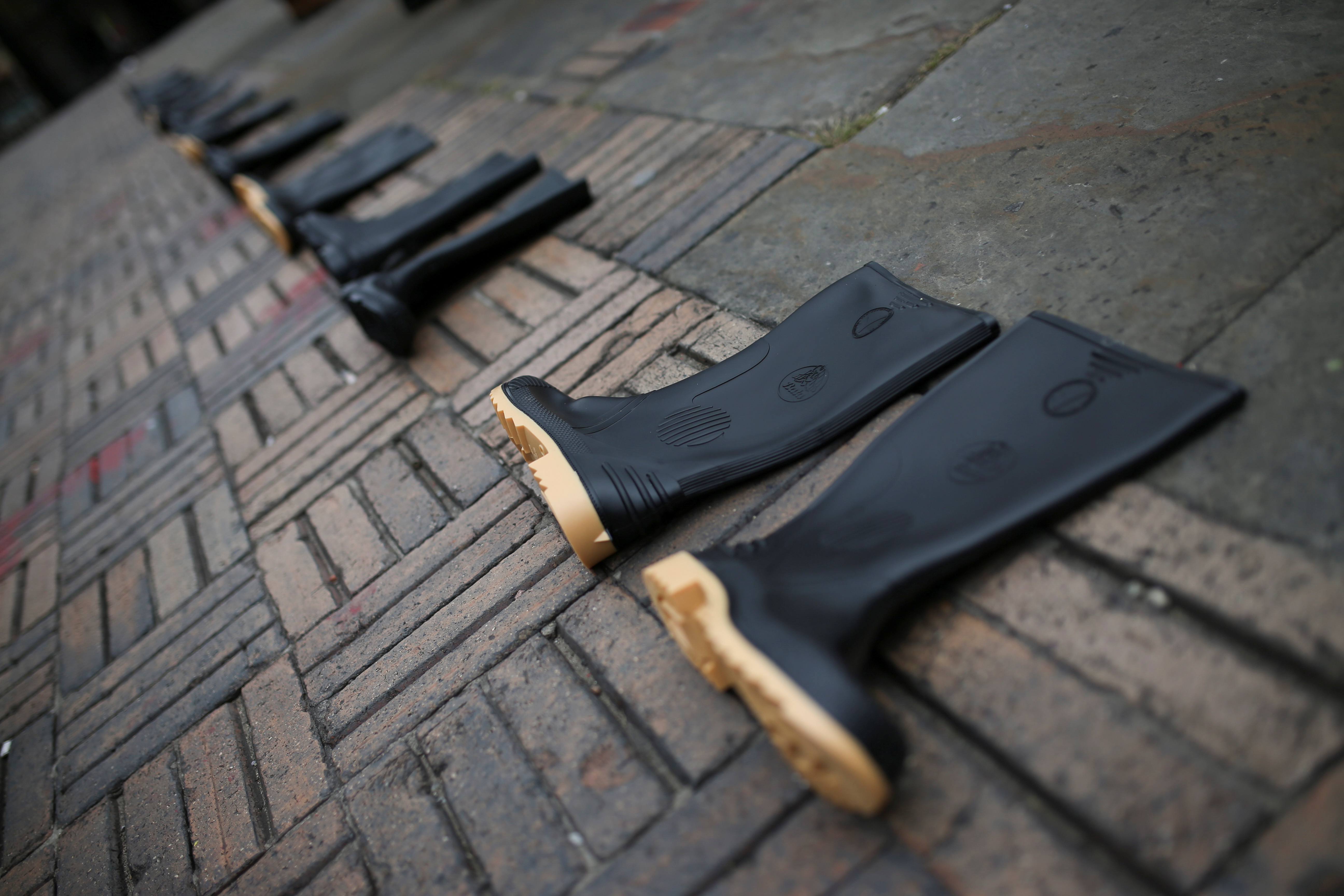 Rubber boots are seen in the Plaza de Bolivar during a symbolic protest to commemorate the more than 6,400 people who were reportedly killed by the army in 'false positive' cases during the war against FARC rebels, in Bogota, Colombia August 30, 2021. REUTERS/Luisa Gonzalez