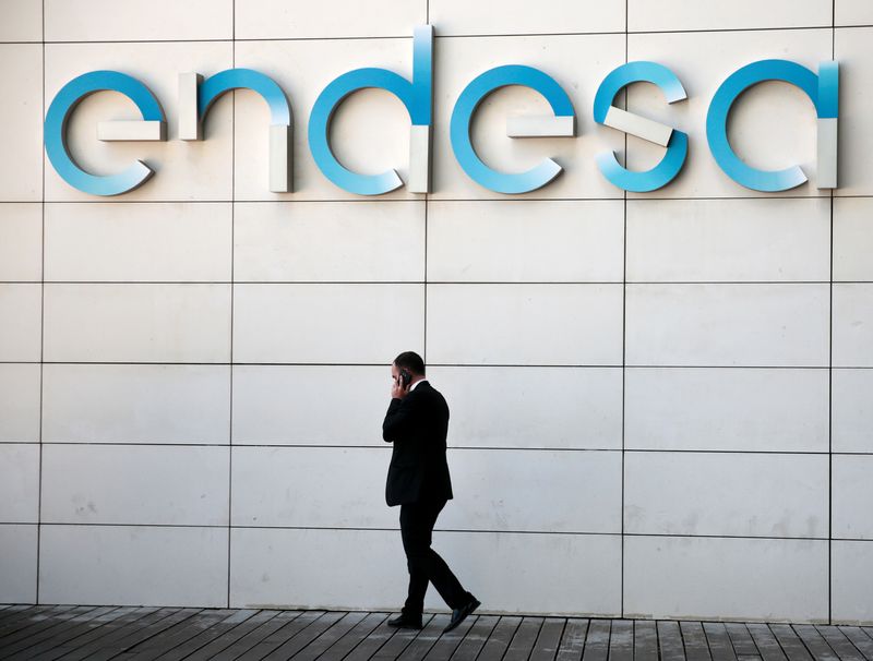 FILE PHOTO.  A man walks under the logo of the Spanish electricity company Endesa at its headquarters in Madrid, Spain.  April 26, 2016. REUTERS/Andrea Comas