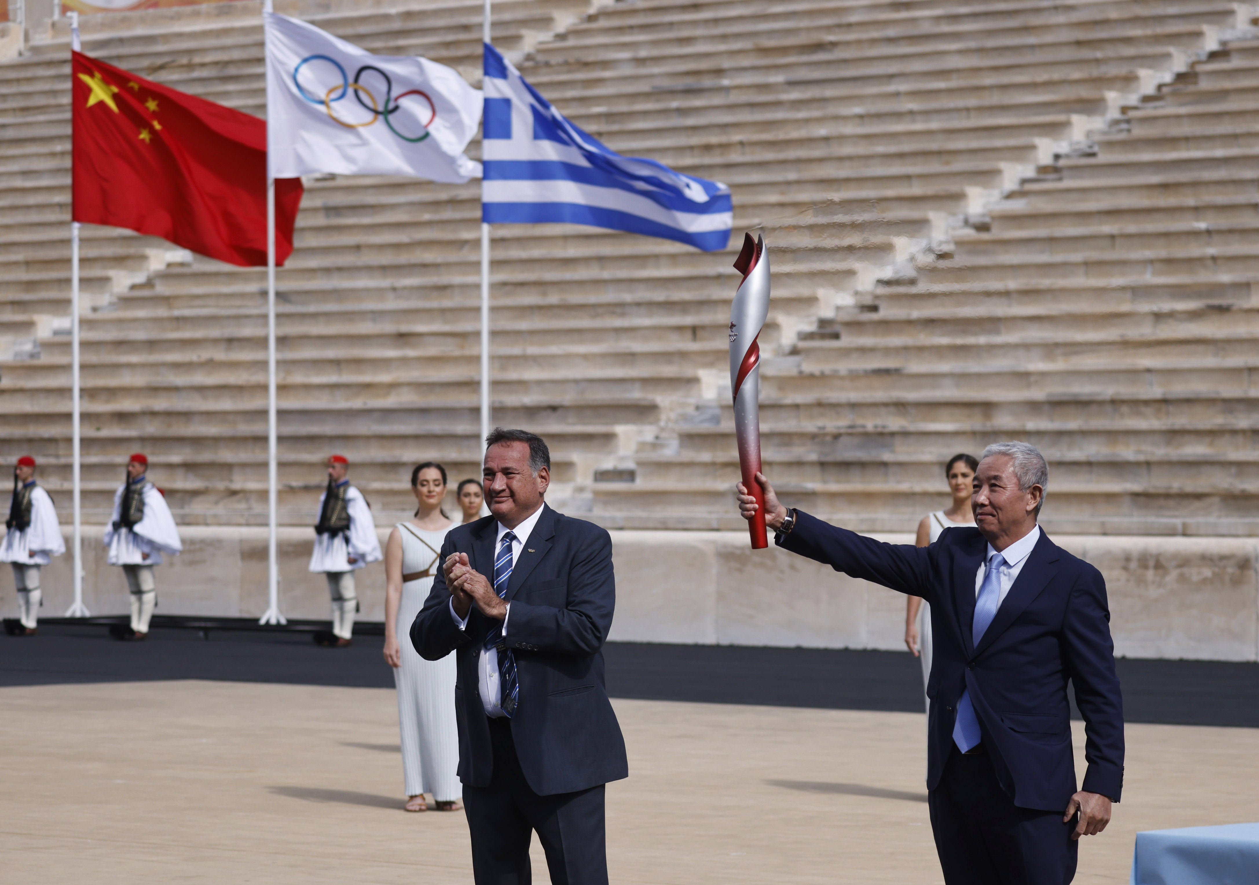 No spectators, no protests as Olympic flame is handed over to Beijing 2022 at historic Panathenaic Stadium in Athens