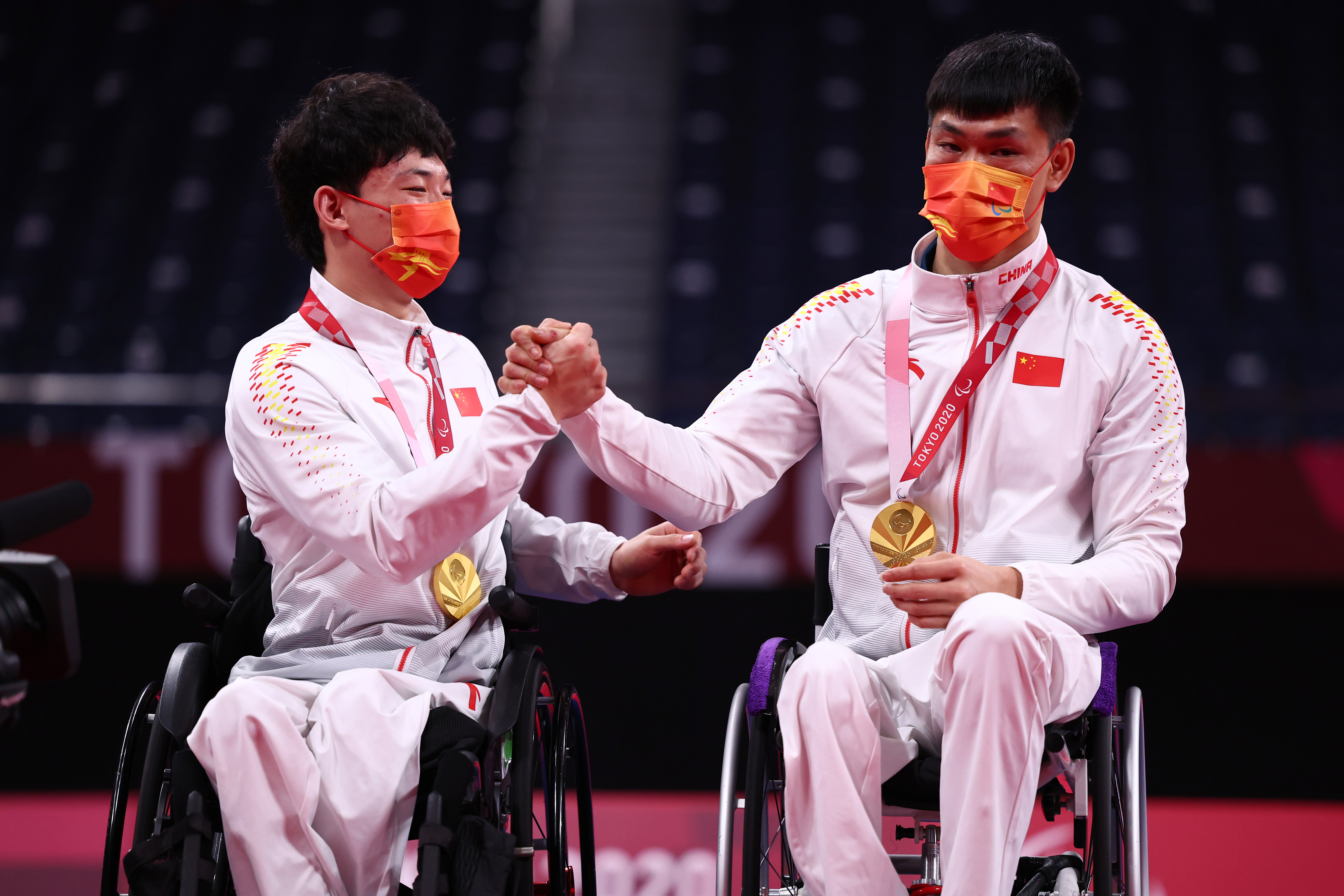 Tokyo 2020 Paralympic Games - Badminton - Men's Doubles WH Medal Ceremony - Yoyogi National Stadium, Tokyo, Japan - September 5, 2021. Gold medallists Zimo Qu of China and Jianpeng Mai of China celebrate on the podium REUTERS/Athit Perawongmetha