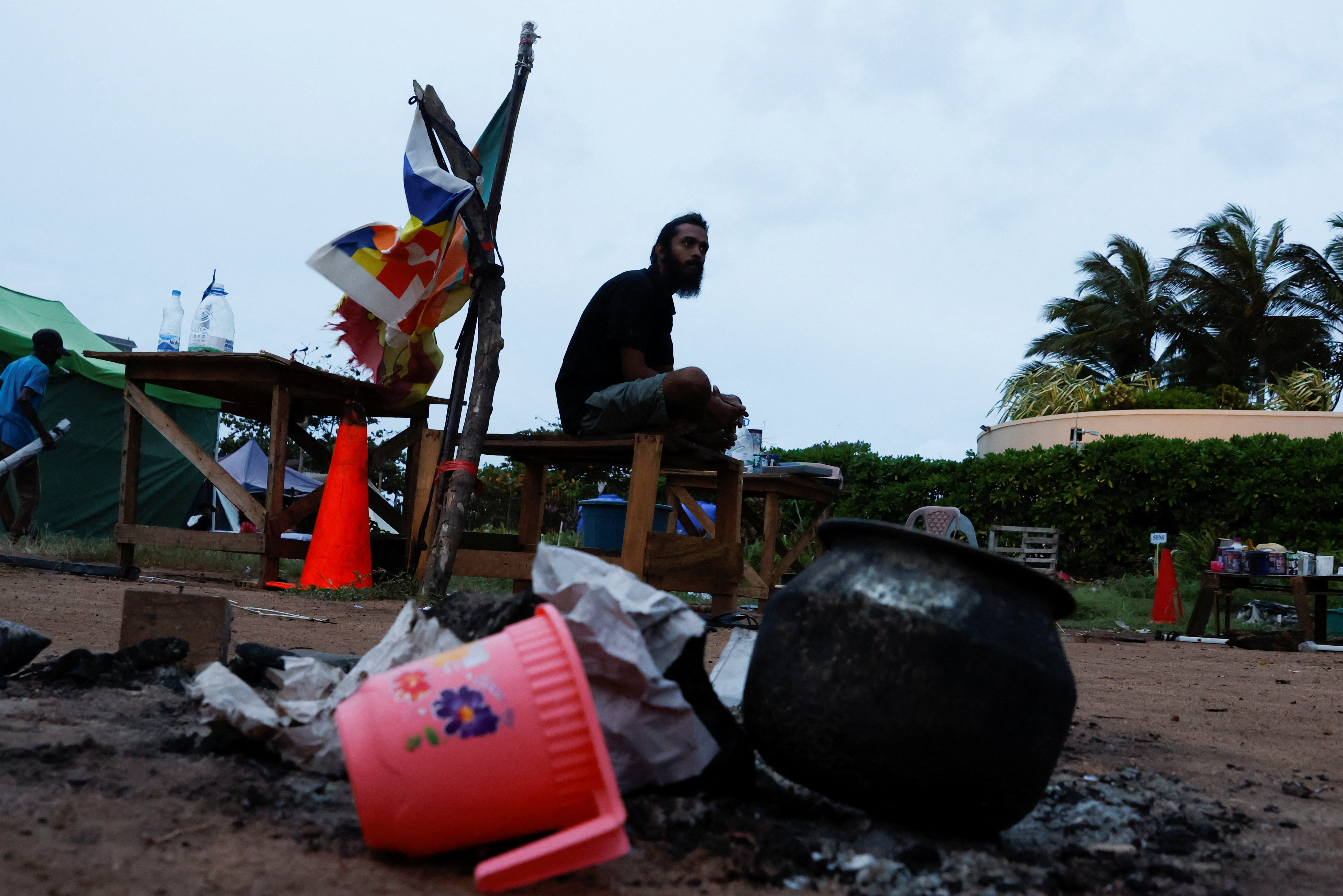 A protester sits in a camp site, after police asked them to leave from a seafront tent camp that became the focal point of months-long nationwide demonstrations, amid the country's economic crisis, in Colombo, Sri Lanka, August 5, 2022. REUTERS/Kim Kyung-Hoon