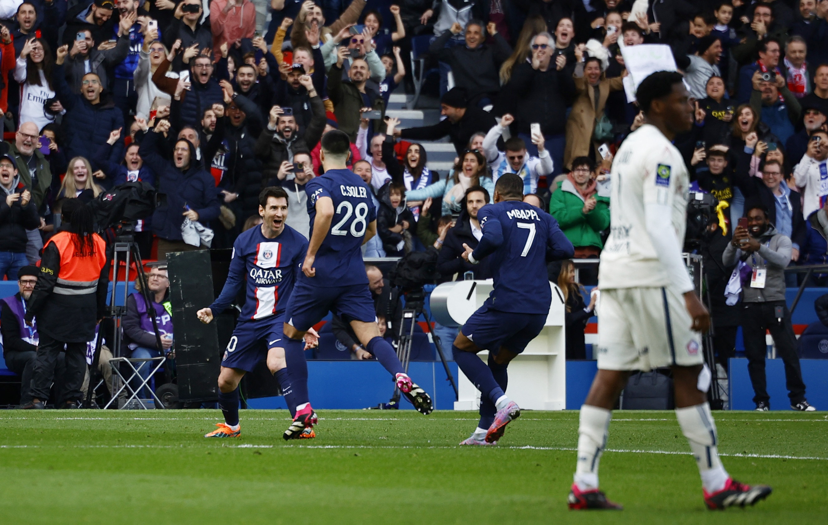 Soccer Football - Ligue 1 - Paris St Germain v Lille - Parc des Princes, Paris, France - February 19, 2023 Paris St Germain's Lionel Messi celebrates scoring their fourth goal with Carlos Soler and Kylian Mbappe REUTERS/Sarah Meyssonnier