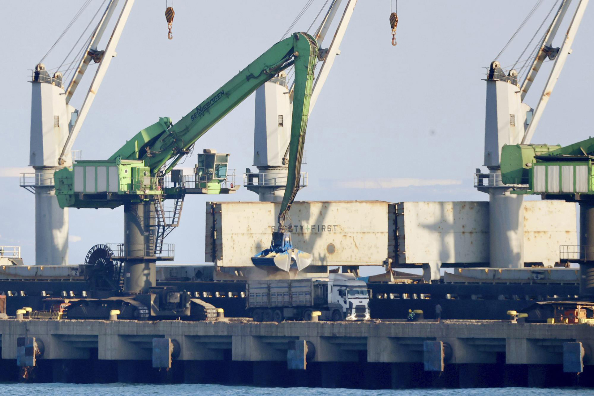 El grano del carguero Mikhail Nenashev se carga en camiones en una acería de propiedad rusa en Dörtyol, Turquía, el 27 de junio de 2022. Una investigación de Associated Press muestra que el barco, propiedad de un contratista de defensa estatal ruso sancionado, es parte de un extensa operación de contrabando dirigida por Rusia que ha estado transportando grano ucraniano robado desde los puertos en la Crimea ocupada a clientes en el Medio Oriente. (Foto AP/Yoruk Isik)