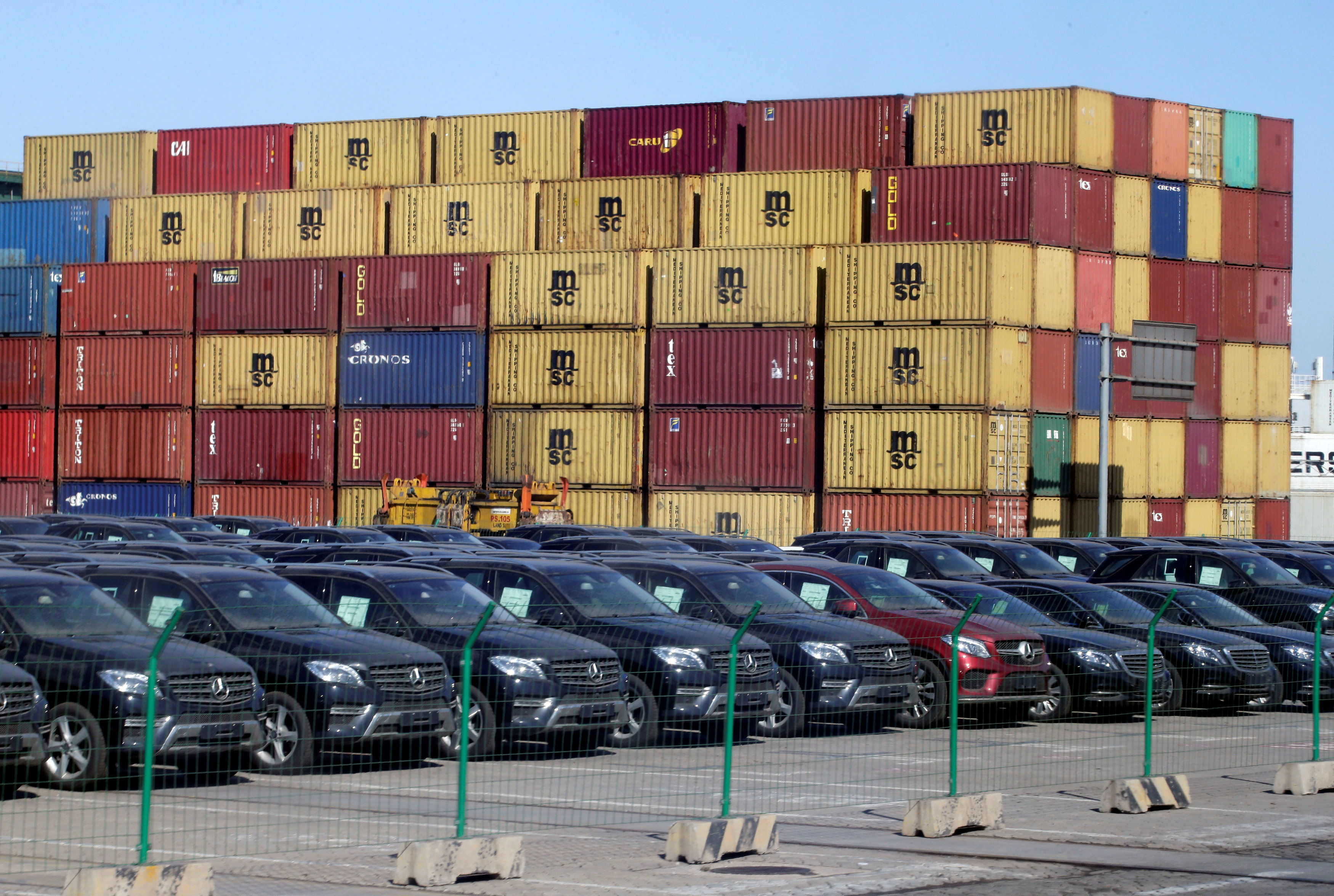 FILE PHOTO: Imported Mercedes Benz cars are seen next to containers at Tianjin Port, in northern China February 23, 2017. REUTERS/Jason Lee/File Photo