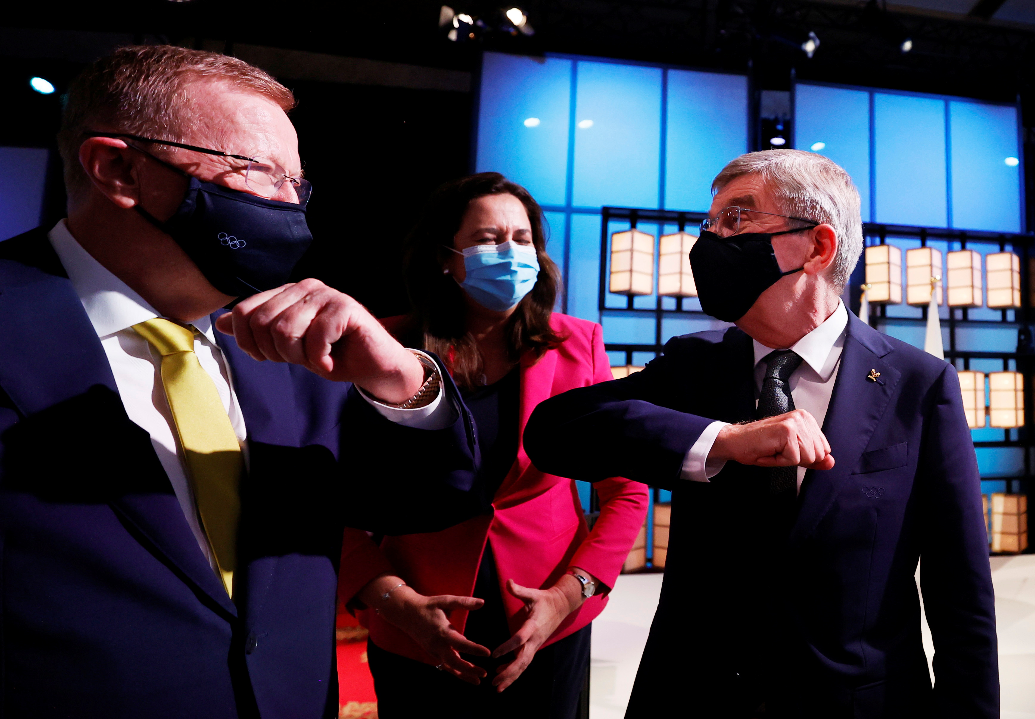 Olympics - 138th IOC Session - Hotel Okura, Tokyo, Japan - July 21, 2021 President of the International Olympic Committee Thomas Bach (R) bumps elbows with members of the Brisbane 2032 delegation (L-R) John Coates AC, President, Australian Olympic Committee and The Honourable Annastacia Palaszczuk MP, Premier of Queensland and Minister for Trade, after Brisbane was announced as the 2032 Summer Olympics host city during the 138th IOC Session Pool via REUTERS/Toru Hanai