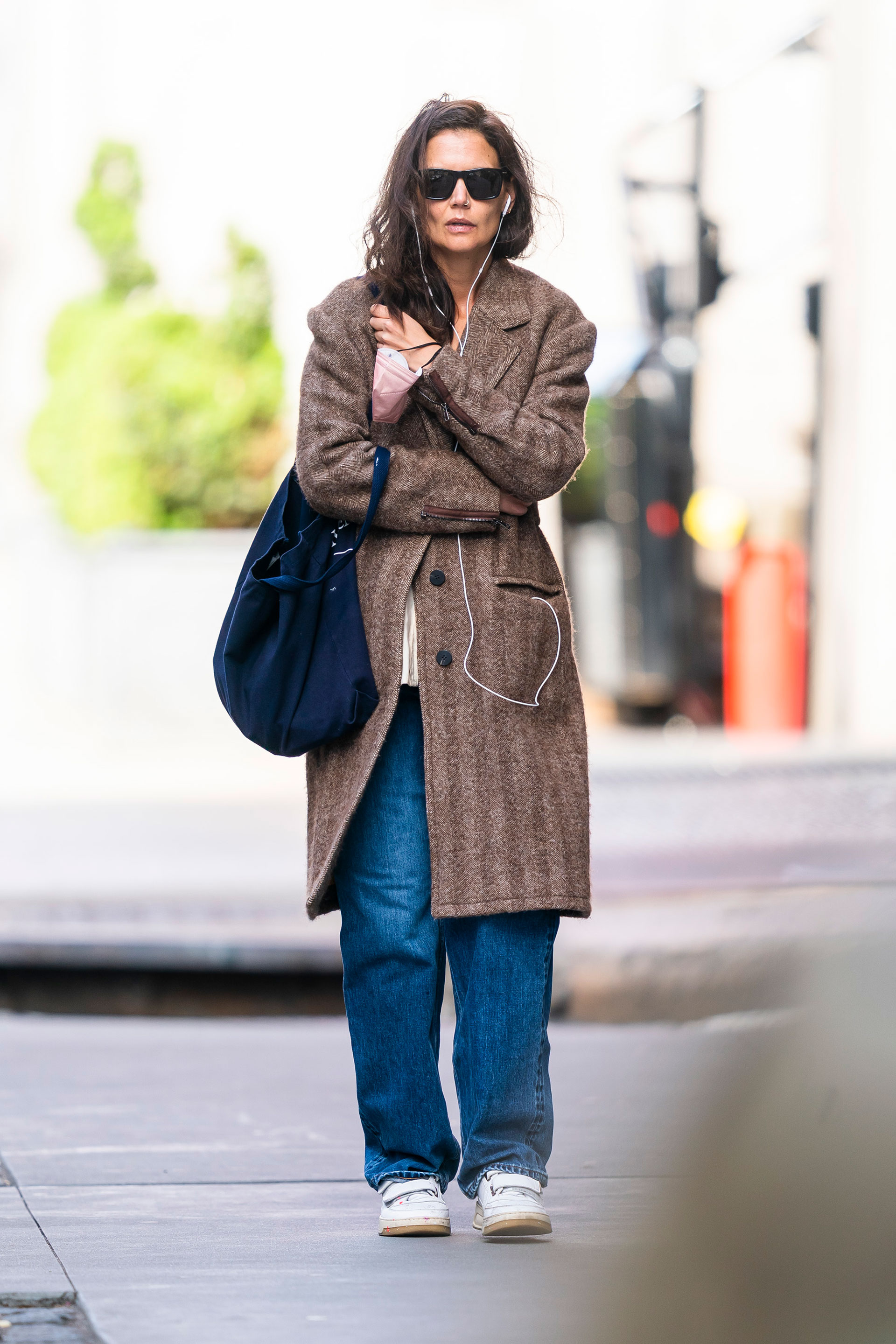 Katie Holmes fue fotografiada mientras daba un paseo por las calles de su vecindario en Nueva York. La actriz lució un jean, un sweater clarito y un tapado marrón. Además, llevó zapatillas blancas, cartera azul, lentes de sol y fue escuchando música con sus auriculares (Fotos: The Grosby Group)