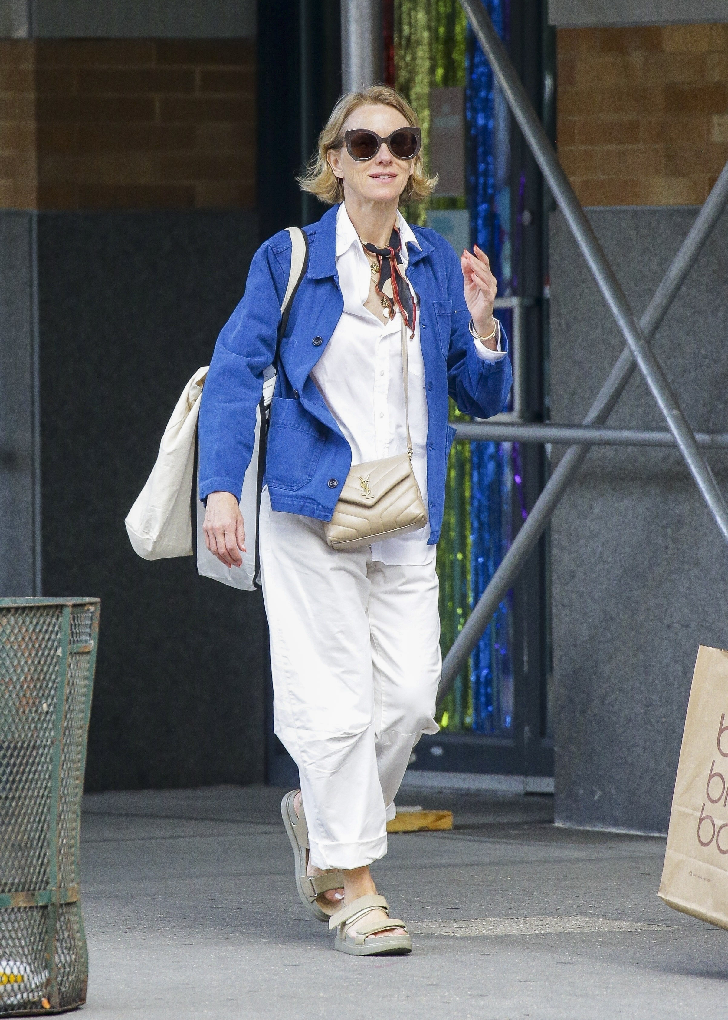 Naomi Watts disfrutó de un día de paseo por las calles de Nueva York. Lució un conjunto de pantalón y camisa color blanco, saco de jean y cartera color cremita que combinó con sus sandalias y un pañuelo negro y rojo