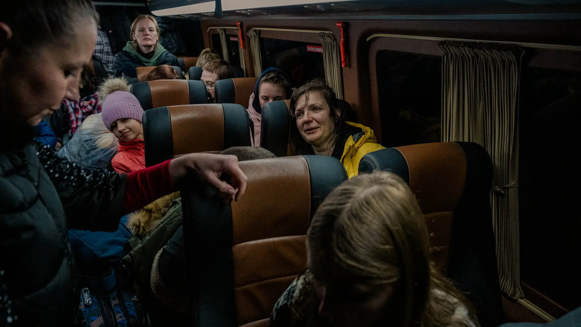 Ukrainian mothers return home with their children, near Kupyansk, Ukraine, March 11, 2023. Making a harrowing 3,000-mile journey from Ukraine to Russian-occupied territory and back, a group of mothers managed to retrieve their children from custody of the Russian authorities.  (Daniel Berehulak/The New York Times)