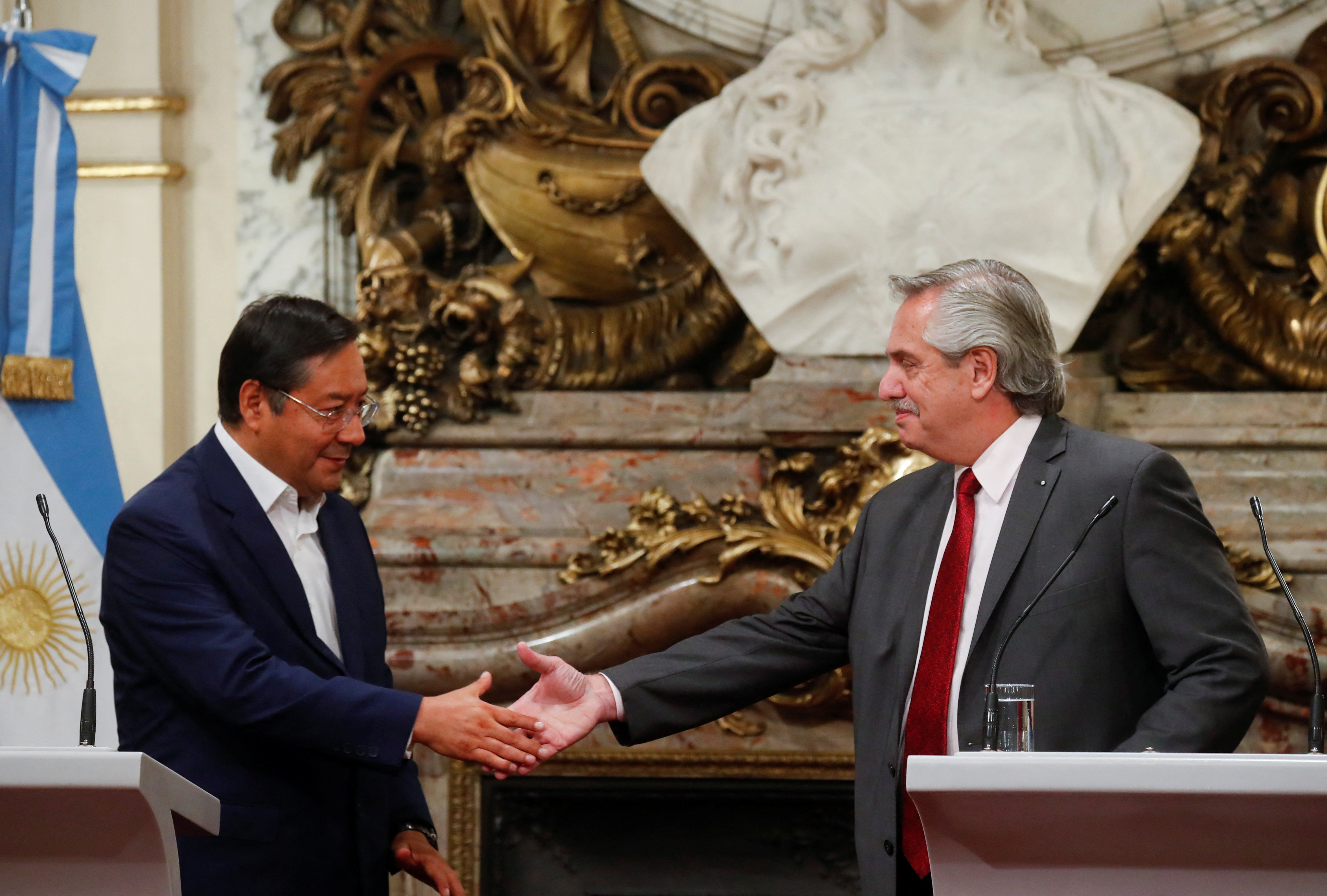 Argentina's President Alberto Fernandez and Bolivia's President Luis Arce shake hands during a bilateral agreement signing ceremony at the Casa Rosada presidential palace in Buenos Aires, Argentina April 7, 2022. REUTERS/Agustin Marcarian