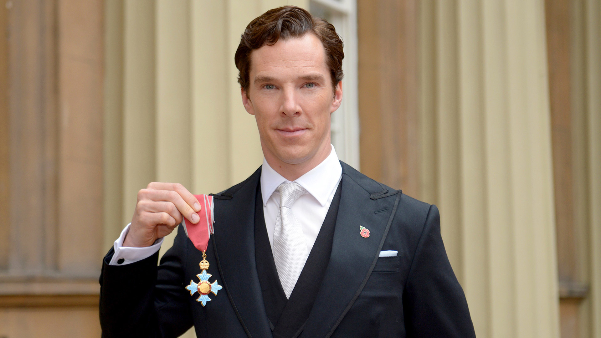 Cumberbatch, in 2015, displays the medal given to him by Queen Elizabeth II for his services to art and philanthropy.  That year he also became a father for the first time (Photo by Anthony Devlin - WPA Pool/Getty Images)