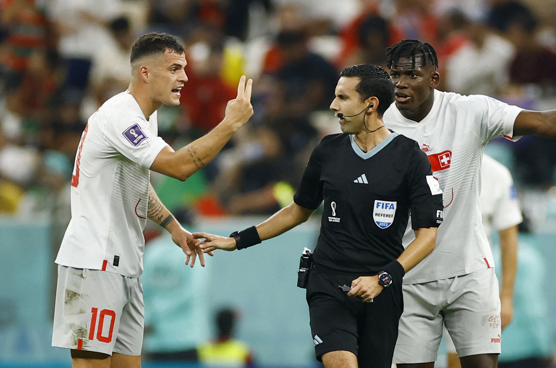 Soccer Football - FIFA World Cup Qatar 2022 - Round of 16 - Portugal v Switzerland - Lusail Stadium, Lusail, Qatar - December 6, 2022 Switzerland's Granit Xhaka remonstrates with referee Cesar Arturo Ramos after Portugal's Goncalo Ramos scores their third goal REUTERS/John Sibley
