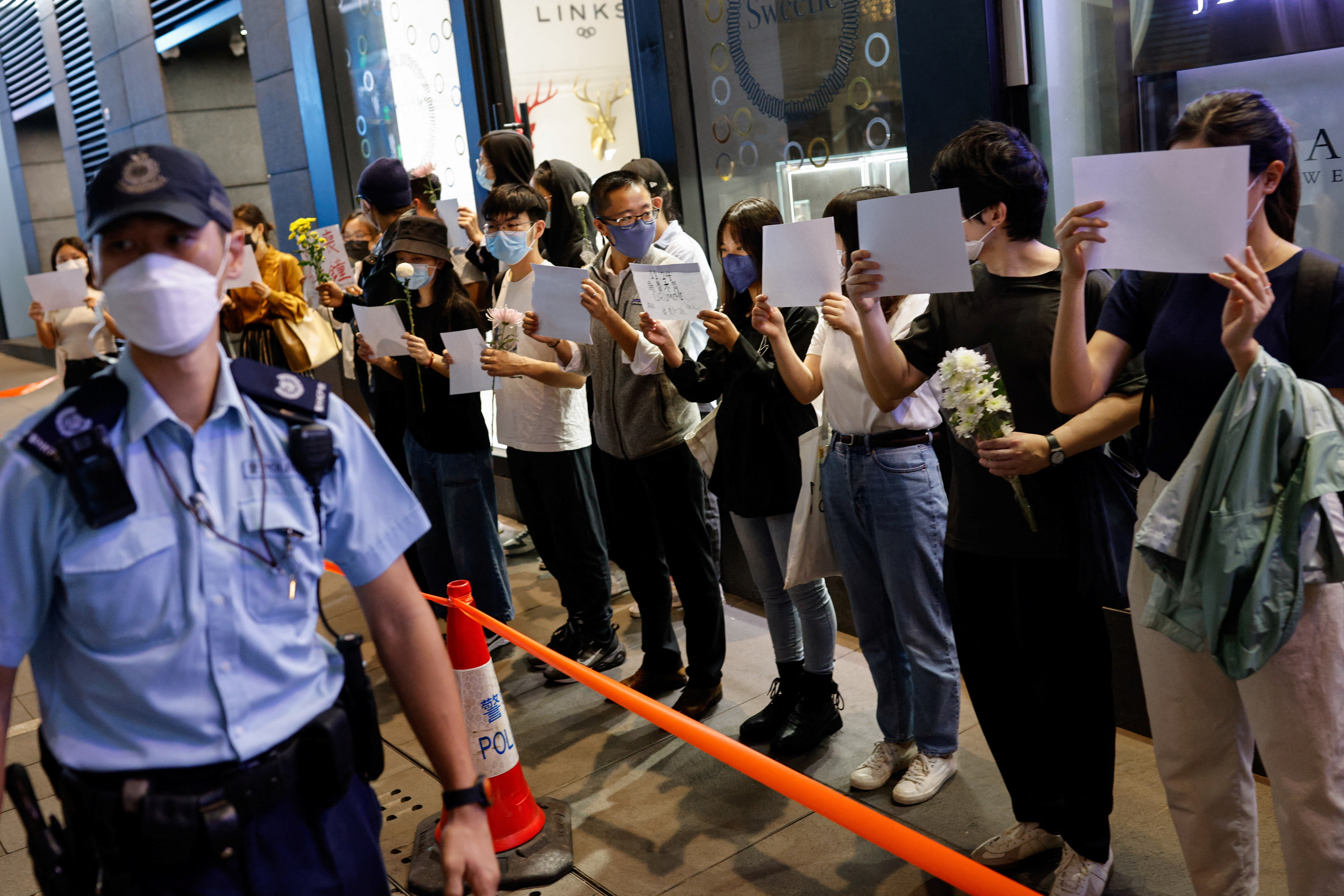 Protesters in Haizhu broke through lockdown barriers and marched through the streets, in a rare show of public anger against health restrictions.  (Reuters)