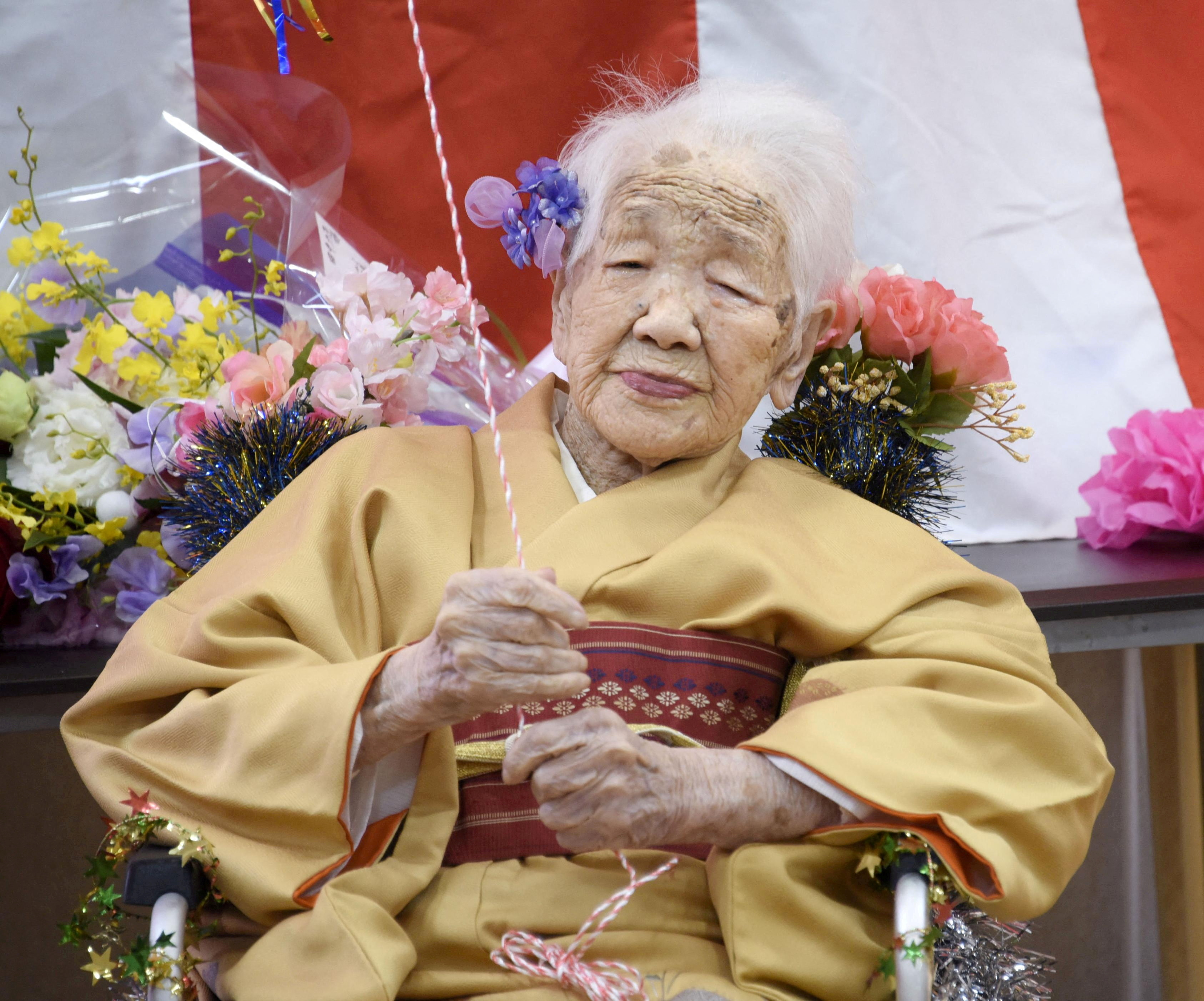 FILE PHOTO: Kane Tanaka, born in 1903, smiles as a nursing home celebrates three days after her 117th birthday in Fukuoka, Japan, in this photo taken by Kyodo January 5, 2020. Mandatory credit Kyodo/via REUTERS ATTENTION EDITORS - THIS IMAGE WAS PROVIDED BY A THIRD PARTY. MANDATORY CREDIT. JAPAN OUT. NO COMMERCIAL OR EDITORIAL SALES IN JAPAN/File Photo