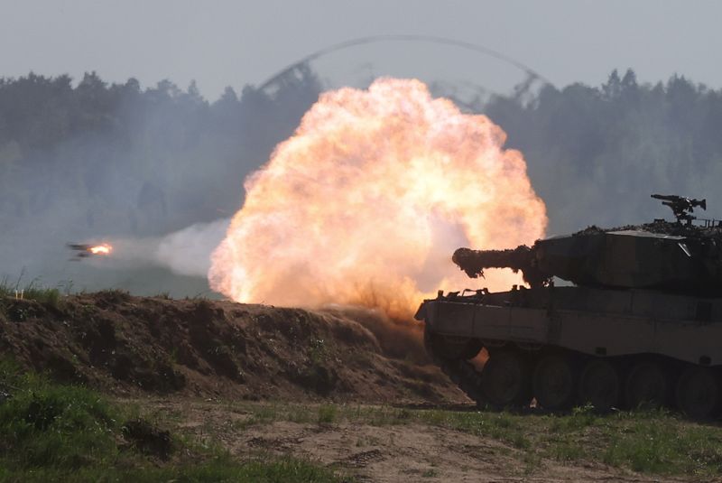 FILE PHOTO: A Polish Leopard 2PL tank fires during the Defender Europe 2022 military exercise of NATO troops, including French, American and Polish troops, amid the Russian invasion of Ukraine, at the Bemowo Piskie military firing range, near Orzysz, Poland May 24, 2022. REUTERS/Kacper Pempel