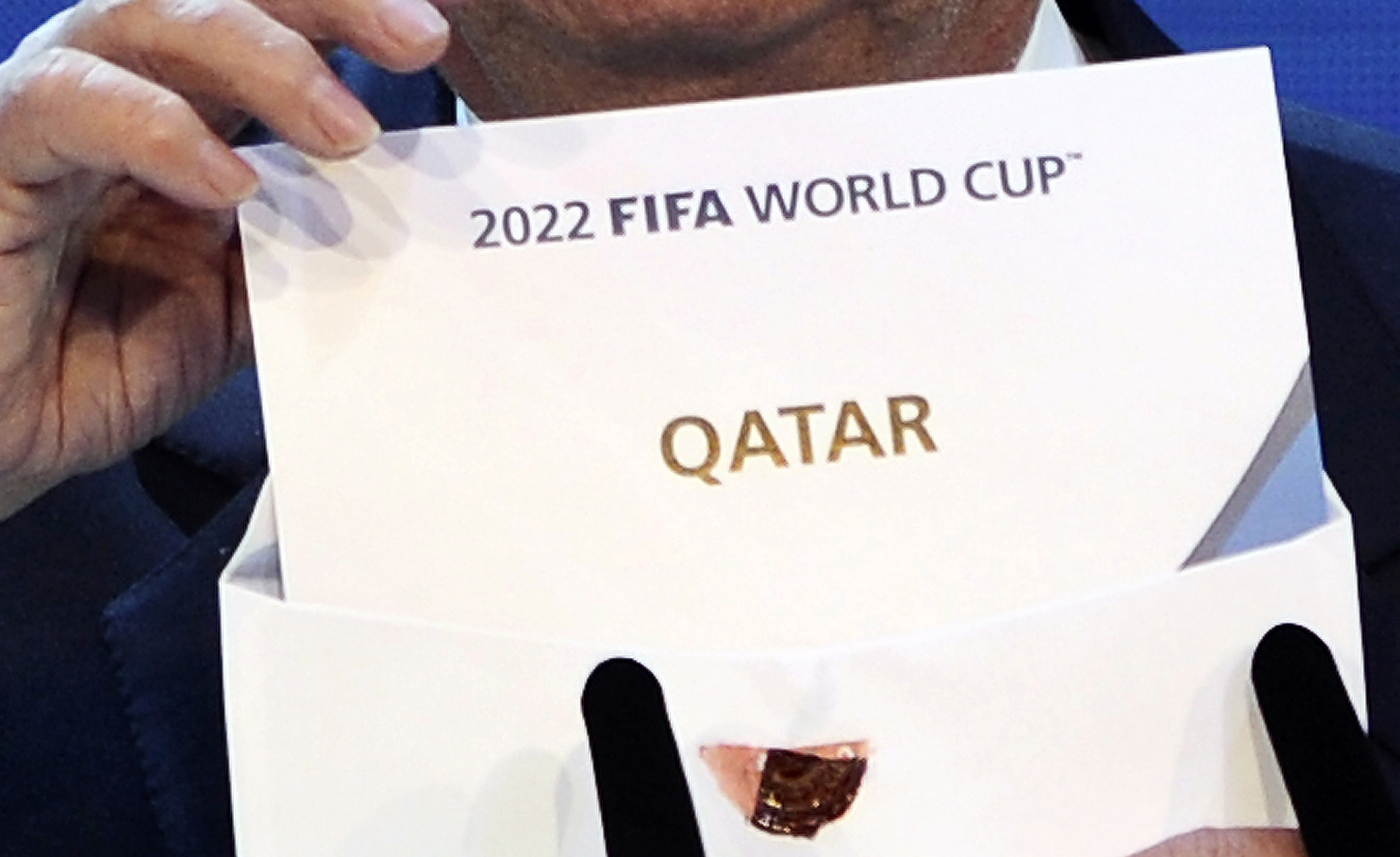 FIFA president Joseph Blatter opens the envelope to reveal that Qatar will host the 2022 World Cup at the FIFA headquarters in Zurich on December 2, 2010. Qatar became the first Arab, Middle Eastern or Muslim country to be awarded the right to stage football's World Cup.  AFP PHOTO / FABRICE COFFRINI (Photo credit should read FABRICE COFFRINI/AFP/Getty Images)