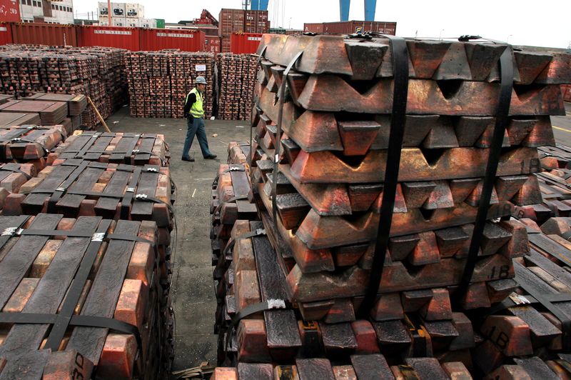File image of a security guard walking next to shipments of copper that will be shipped to Asia, in the port of Valparaíso, Chile.  August 21, 2006. REUTERS/Eliseo Fernandez