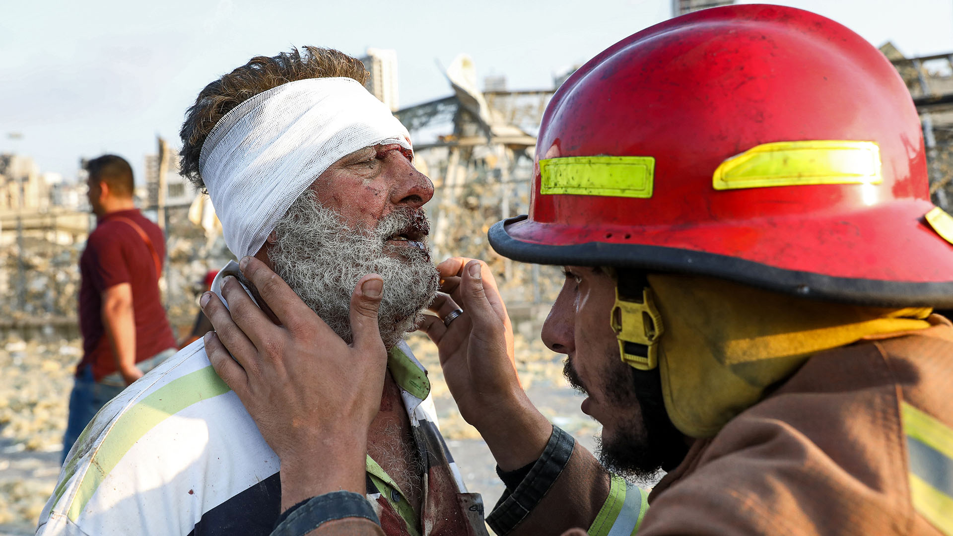 Un bombero atiende a una persona herida en la explosión (AFP)