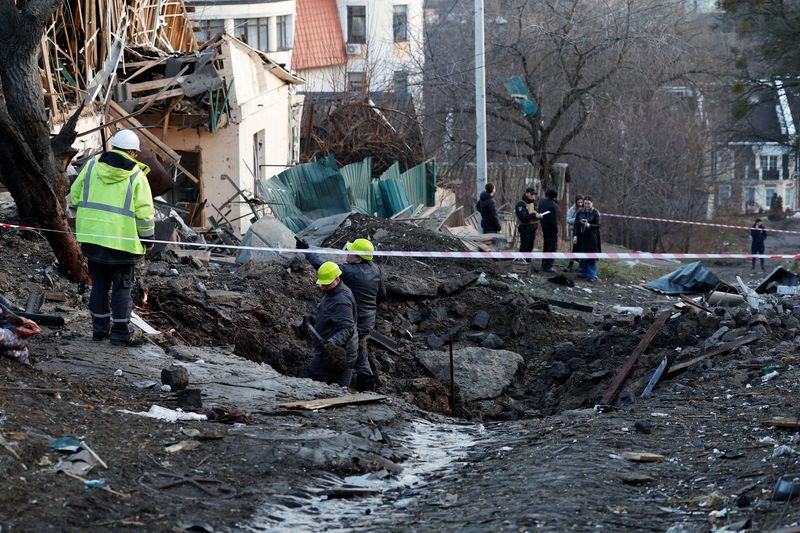 Personas trabajan en un sitio de un ataque con misiles rusos, en medio del ataque de Rusia a Ucrania, en Kiev (Reuters)