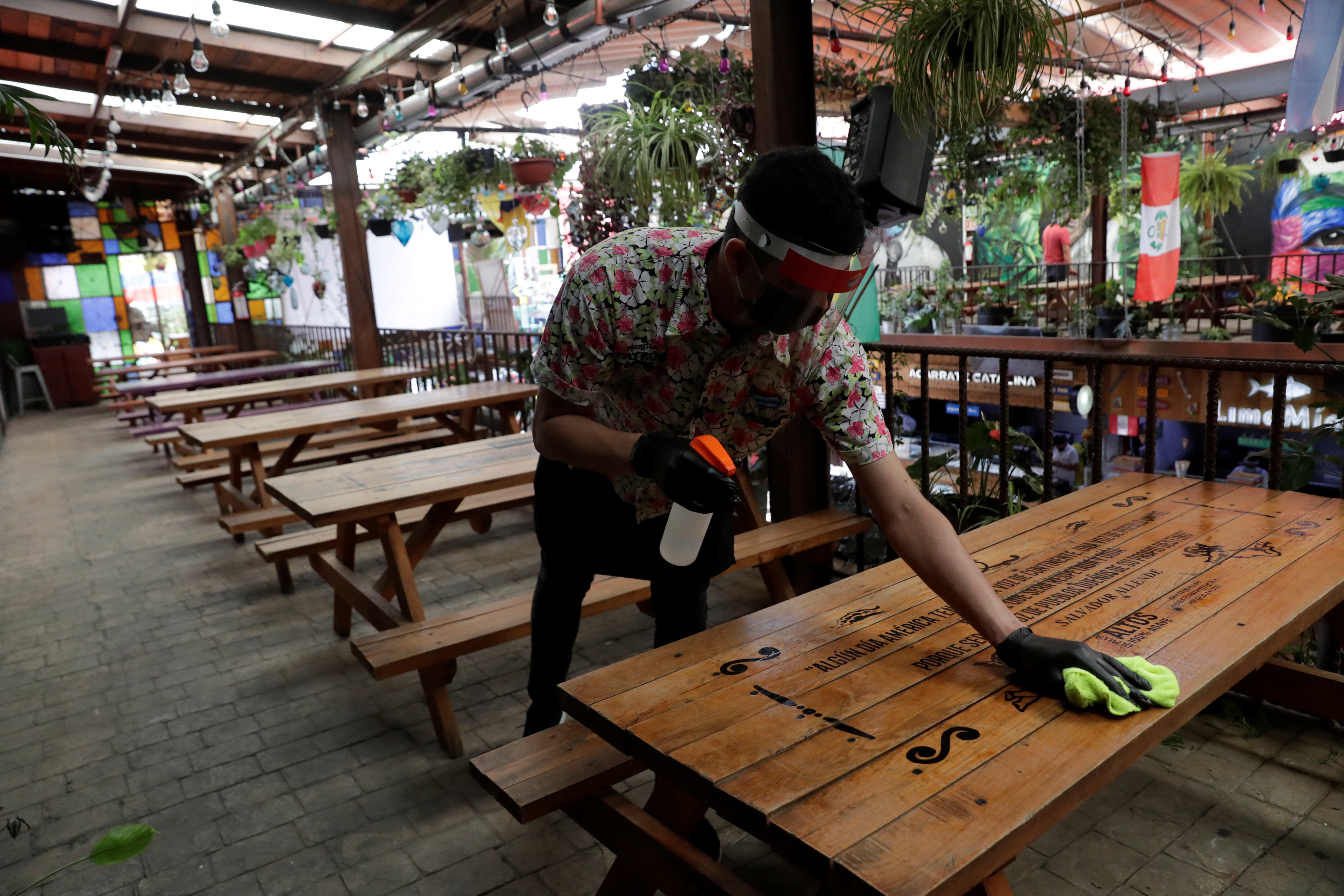 Un camarero limpia una mesa mientras espera que el restaurante Comedor de los Milagros vuelva a abrir, durante el inicio de la reapertura gradual de las actividades comerciales en la ciudad, a medida que continúa el brote de la enfermedad por coronavirus (COVID-19), en la Ciudad de México, México, el 30 de junio. 2020. (Foto: REUTERS / Henry Romero)