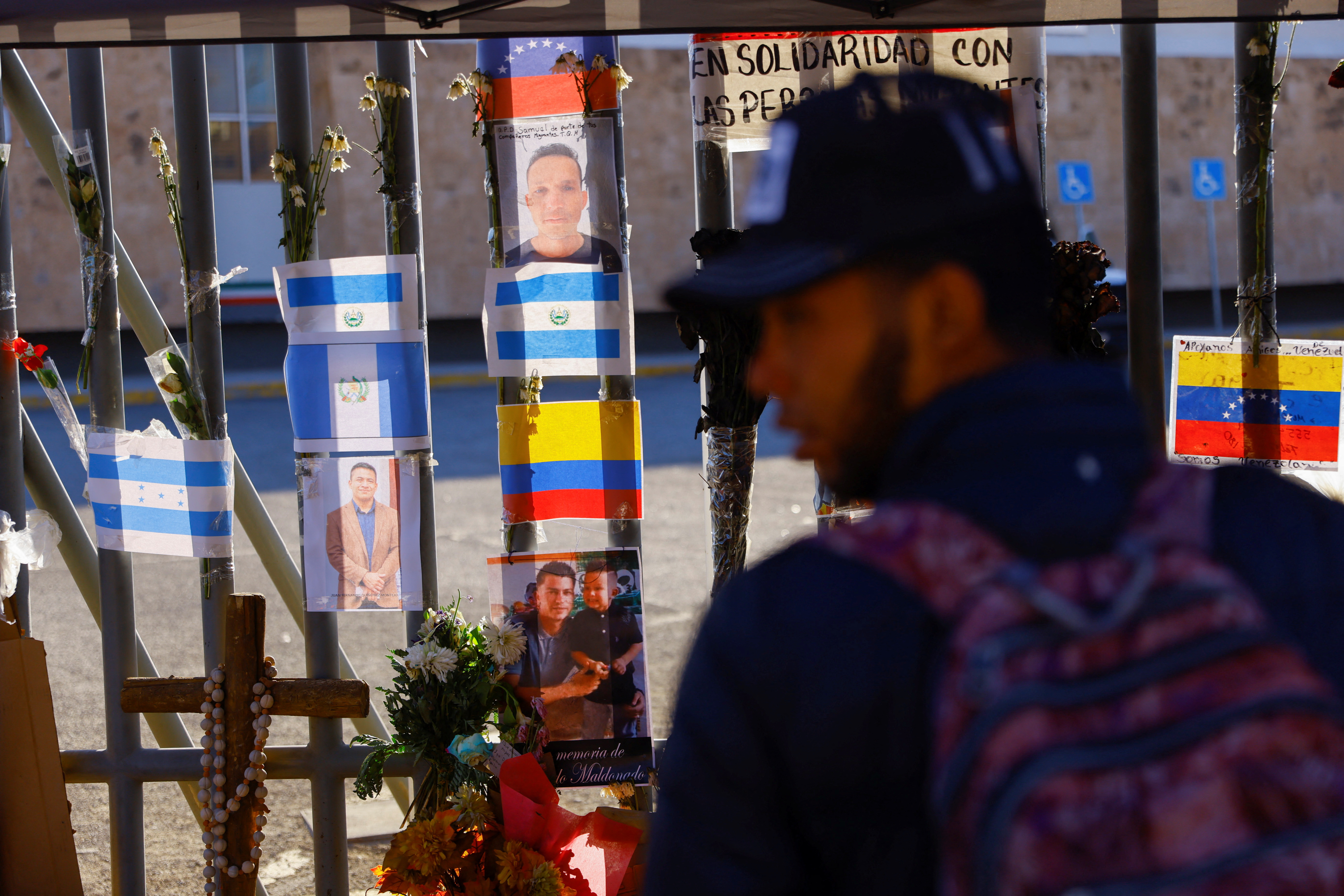 A migrant stands near a makeshift memorial outside the immigration detention center where several migrants died after a fire broke out Monday night, in Ciudad Juarez, Mexico, March 31, 2023. Photo: REUTERS/Jose Luis Gonzales