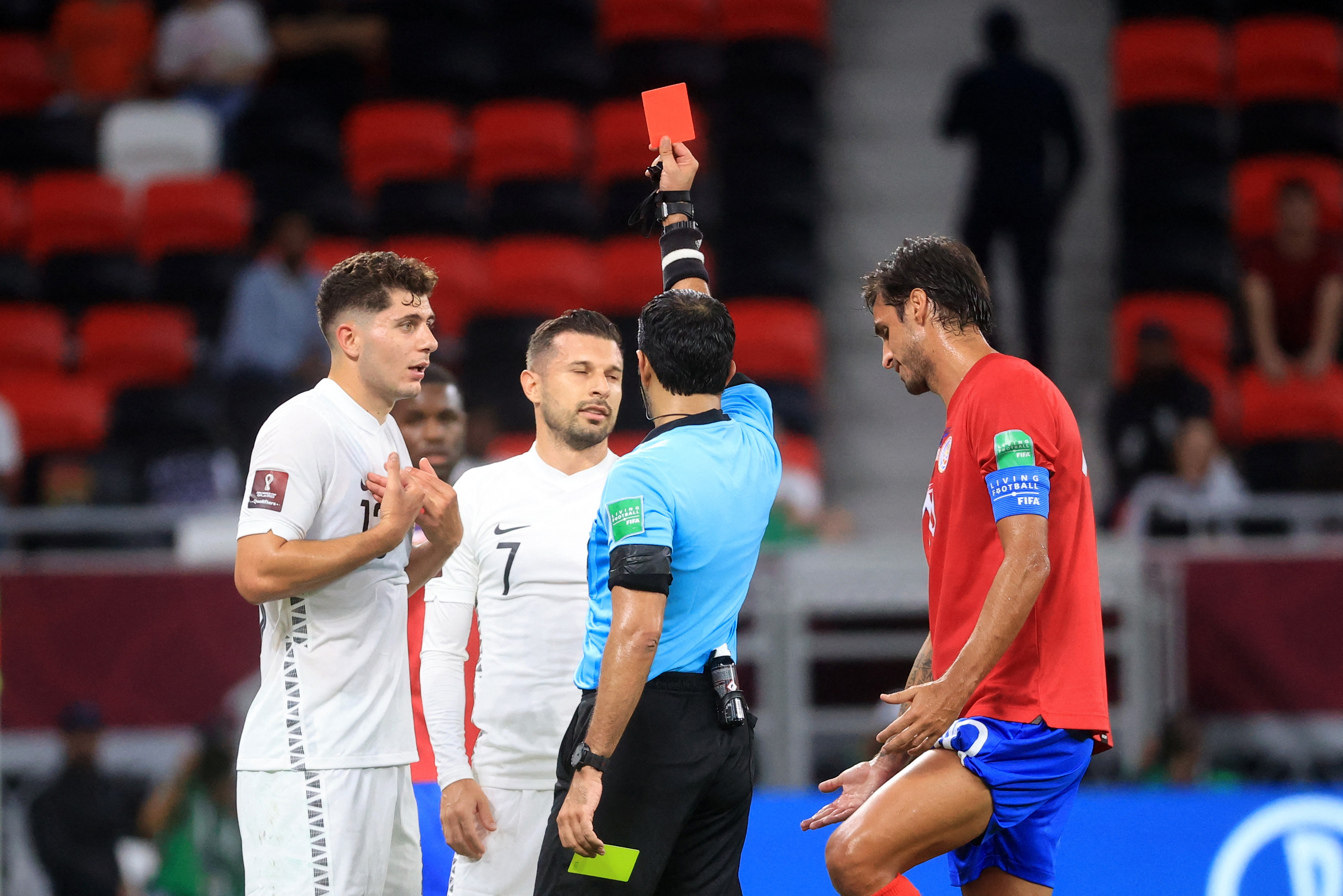 Soccer Football - FIFA World Cup Qualifier - Costa Rica v New Zealand - Al Rayyan Stadium, Al Rayyan, Qatar - June 14, 2022 New Zealand's Kosta Barbarouses is shown a red card by referee Abdulla Hassan Mohammed REUTERS/Mohammed Dabbous