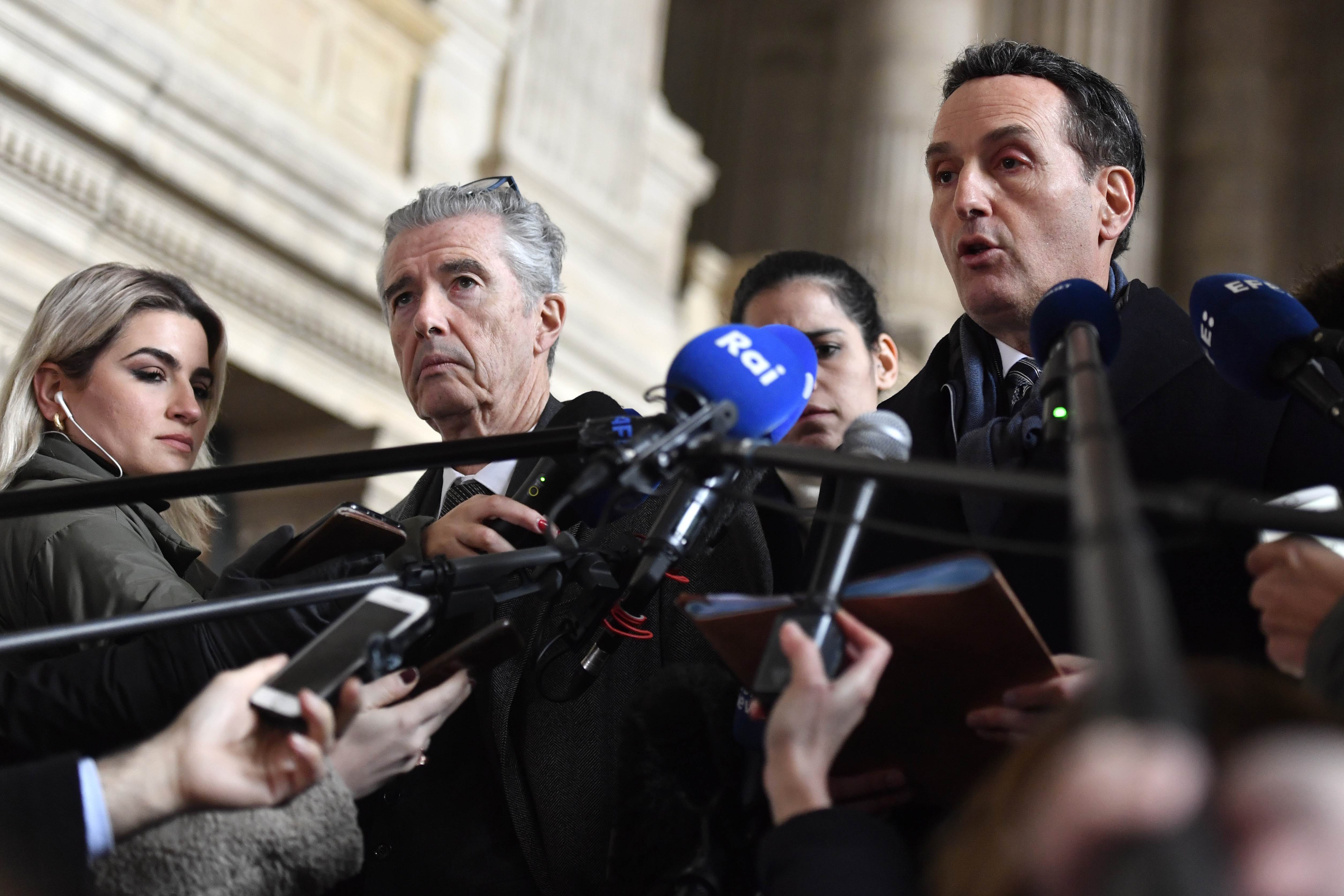 European lawmaker Eva Kaili's lawyer, Andre Risopolous, second left, speaks to the media after a hearing at the Palace of Justice in Brussels, Thursday, Jan. 19, 2023. (AP Photo/Geert Vanden Wijngaert )
