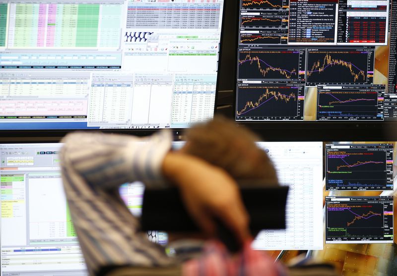 FILE PHOTO.  A trader sits in front of computer screens at his desk at the Frankfurt Stock Exchange, Germany.  June 29, 2015. REUTERS/Ralph Orlowski