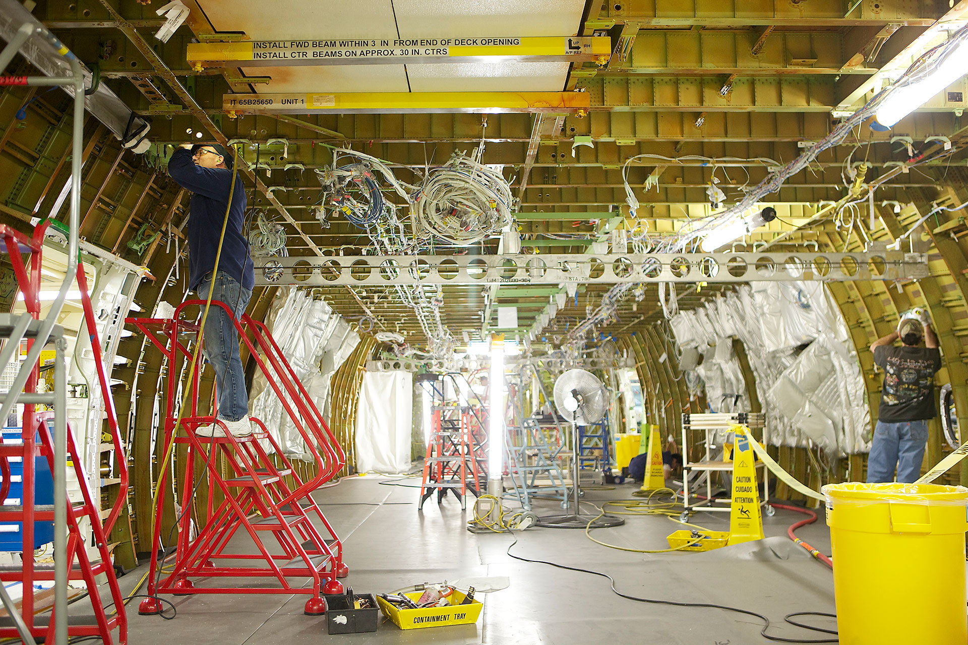 Boeing employees work on the fuselage section of the 747-8 Intercontinental airliner, Boeing's new passenger jet at the Boeing factory February 12, 2011 in Everett, Washington.  Stephen Brashear/Getty Images/File