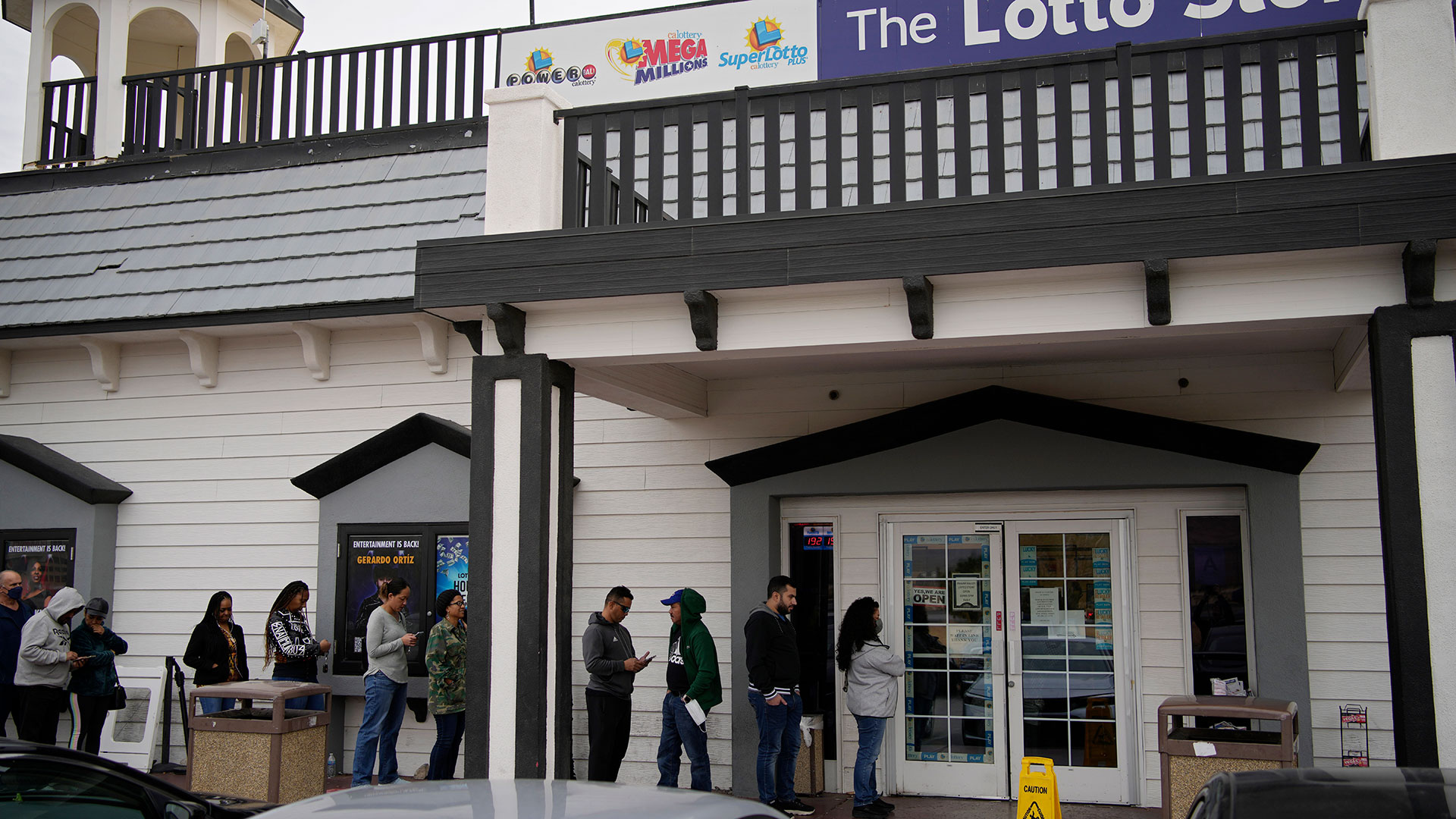 La gente espera en la cola de la Lotto Store de Primm, justo dentro de la frontera con California, el viernes 13 de enero de 2023, cerca de Primm, Nev. (AP/John Locher)
