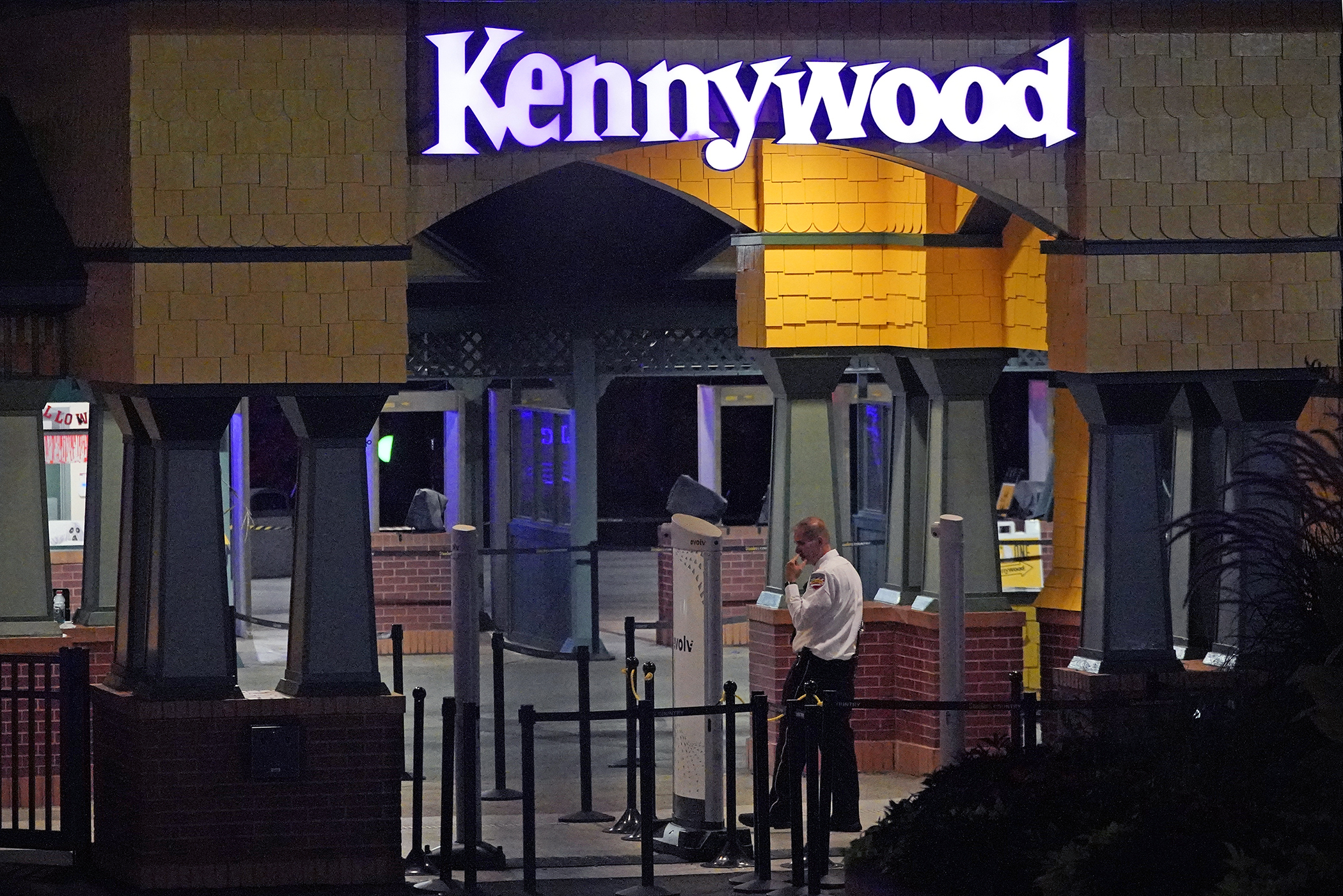 Un guardia de seguridad de Kennywood Park se encuentra en la entrada principal del parque de diversiones en West Mifflin, Pensilvania, la madrugada del domingo 25 de septiembre de 2022.  (AP Foto/Gene J. Puskar)

