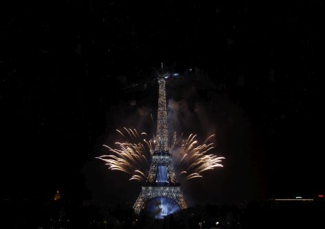 PARIS, FRANCE - JULY 14:  Fireworks burst around the Eiffel Tower as part of Bastille Day celebrations on July 14, 2015 in Paris, France. Bastille Day commemorates the storming by Parisians of the Bastille fortress and prison on July 14, 1789 in Paris.  (Photo by Thierry Chesnot/Getty Images)