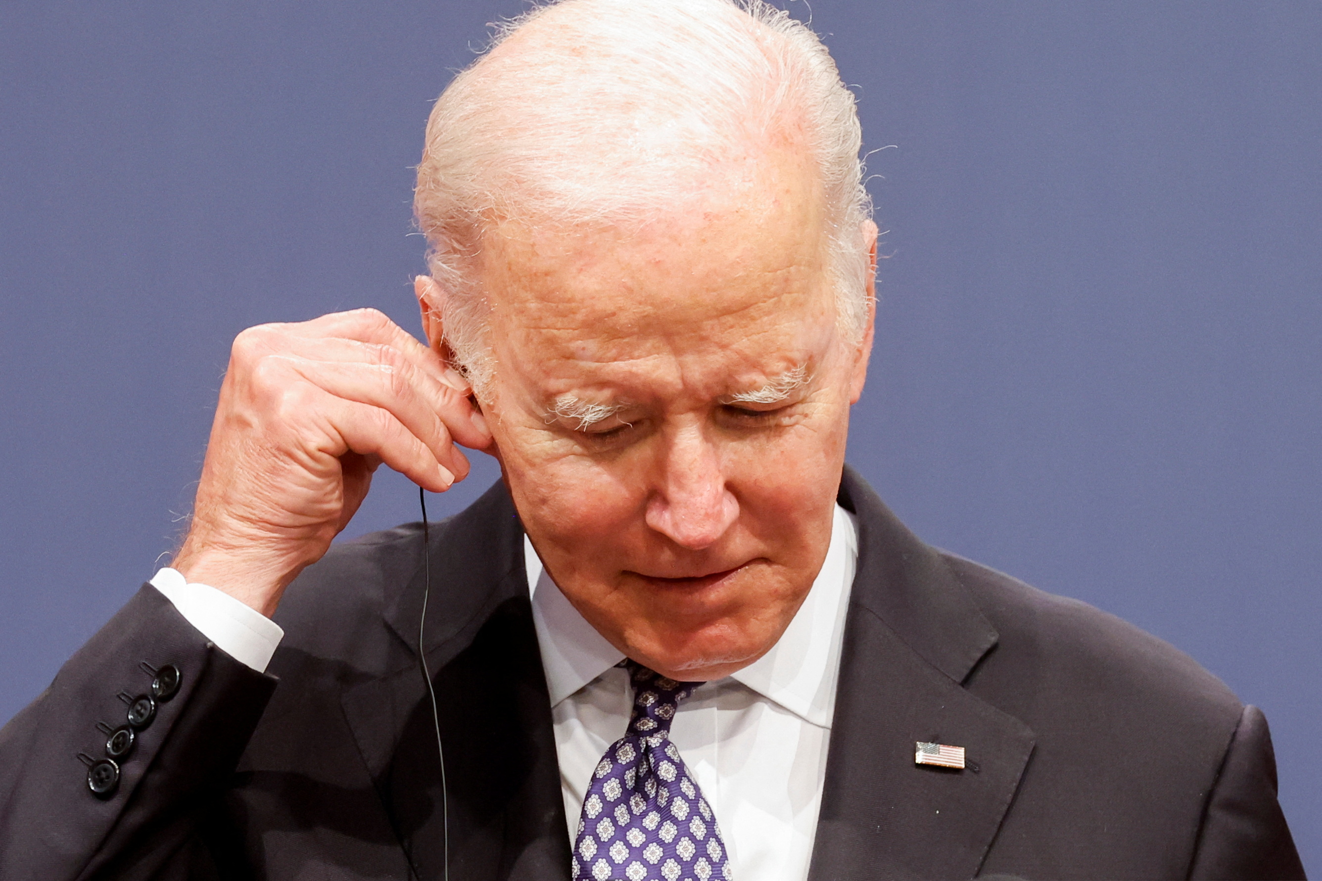 U.S. President Joe Biden adjusts his earpiece during a joint news conference with South Korean President Yoon Suk-youl (not pictured) at the People's House in Seoul, South Korea, May 21, 2022. REUTERS/Jonathan Ernst
