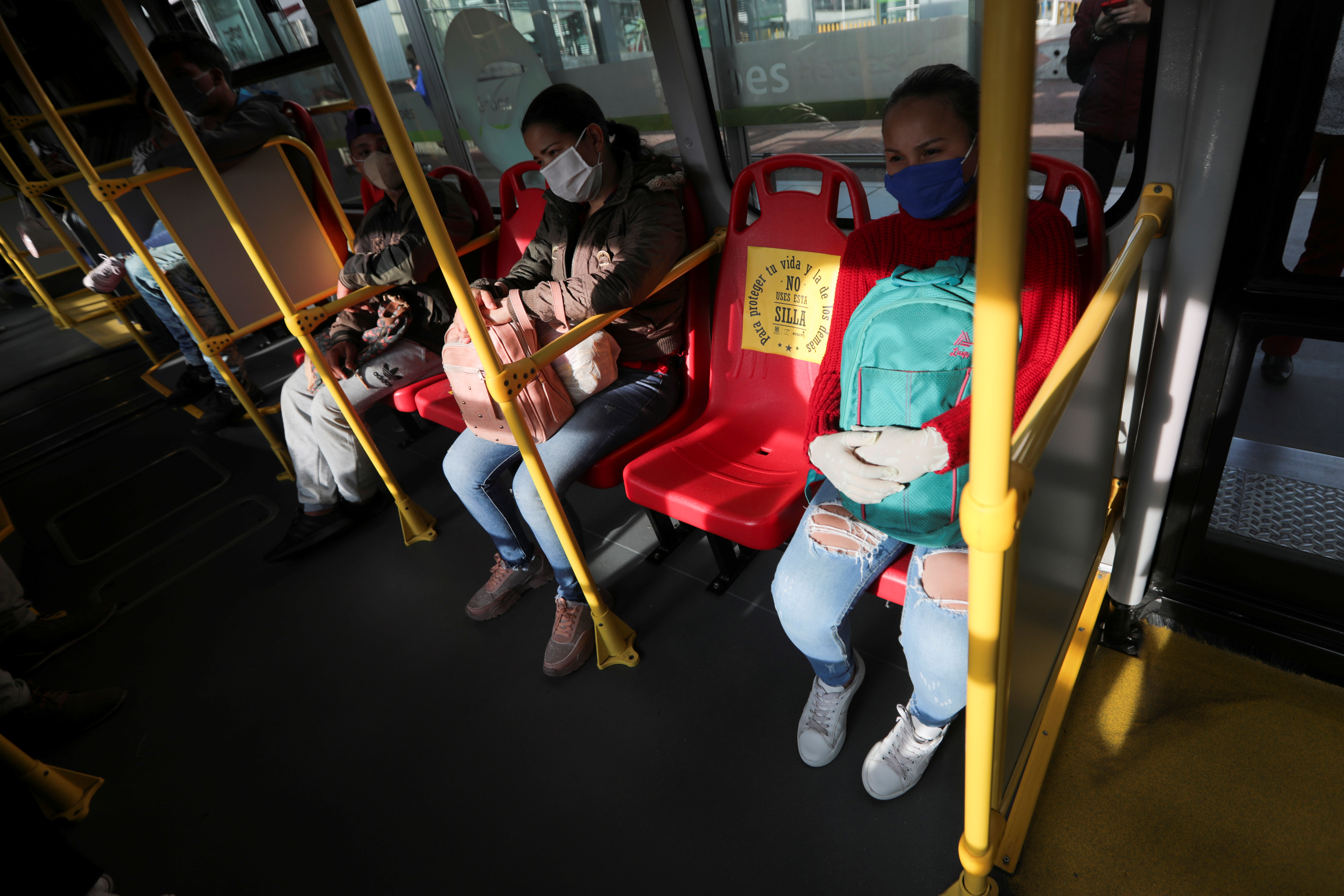 A seat with a sign that reads "To protect your life and the lives of others, do not use this seat" is seen inside a Transmilenio transport system bus, after the government allowed certain sectors to return to work, amid the outbreak of the coronavirus disease (COVID-19) in Bogota, Colombia May 11, 2020. REUTERS/Luisa Gonzalez