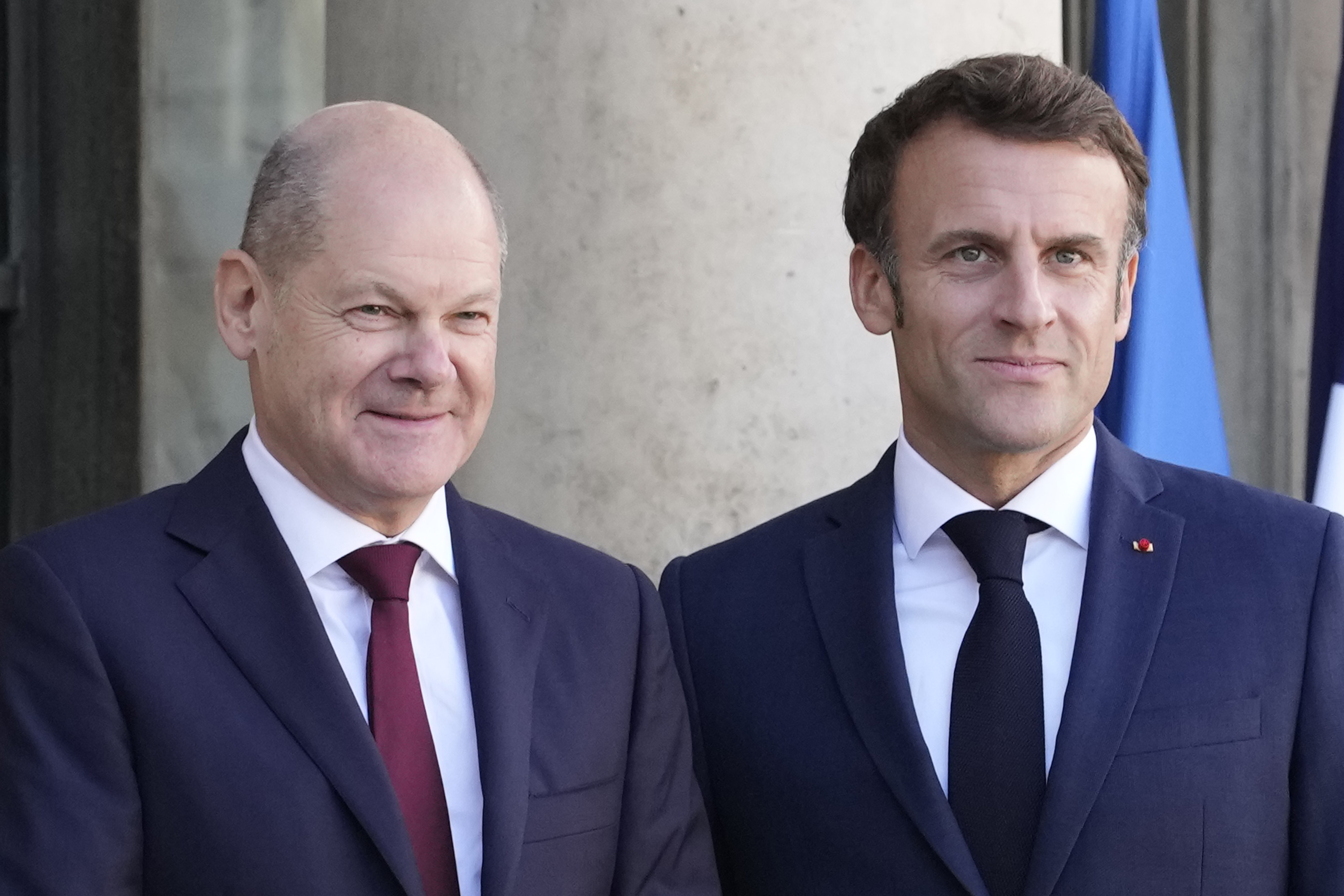 FILE - French President Emmanuel Macron, right, receives German Chancellor Olaf Scholz at the Elysee Palace in Paris on Oct. 26, 2022. (AP Photo/Christophe Ena, File)