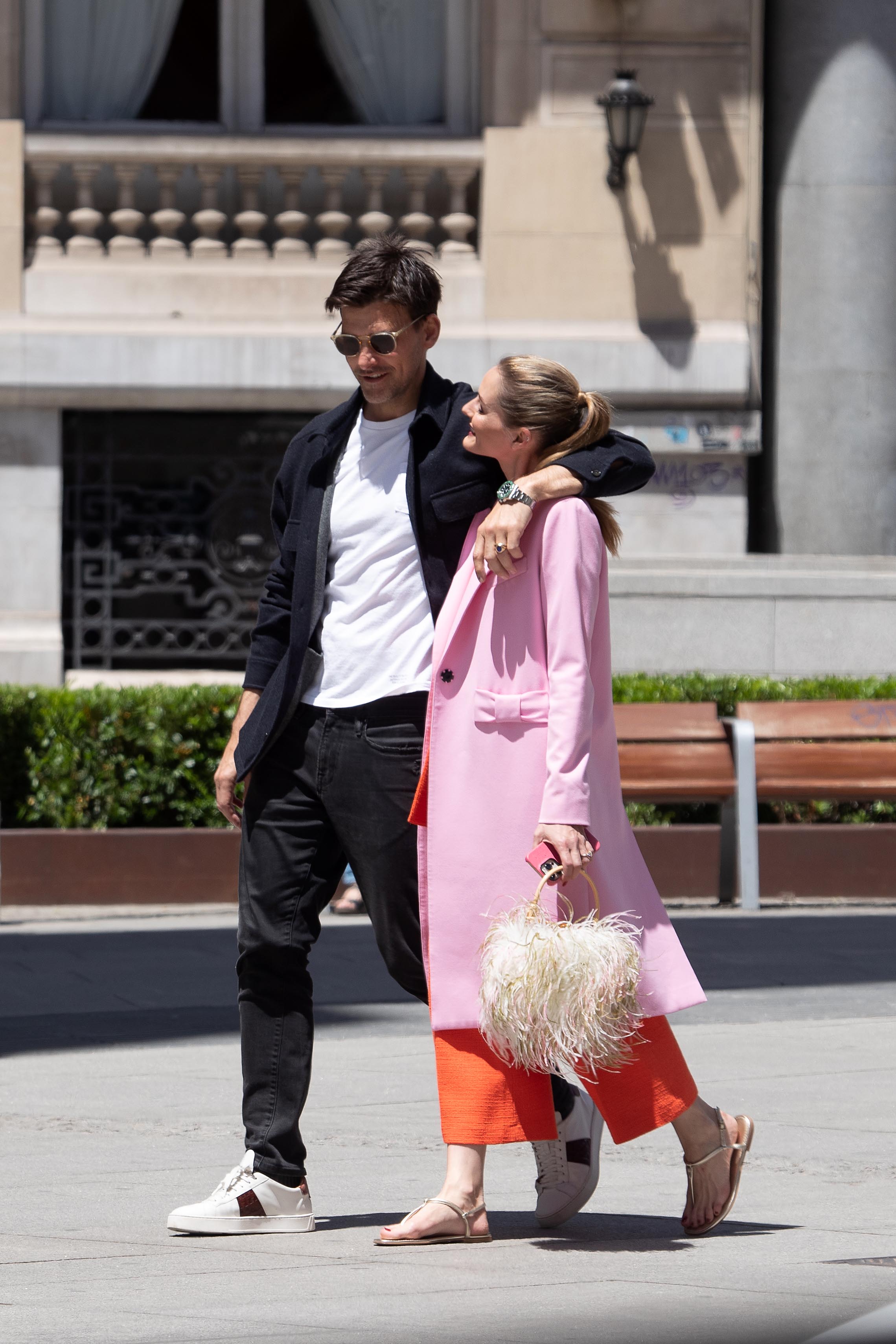 romantic walk  Olivia Palermo and Johannes Huebl were photographed as they walked through the streets of Madrid with their arms around each other.  She wore a red outfit with a pink coat that had details of bows in her pockets and a synthetic feather wallet, while he opted for black pants with a classic white shirt and a black coat.