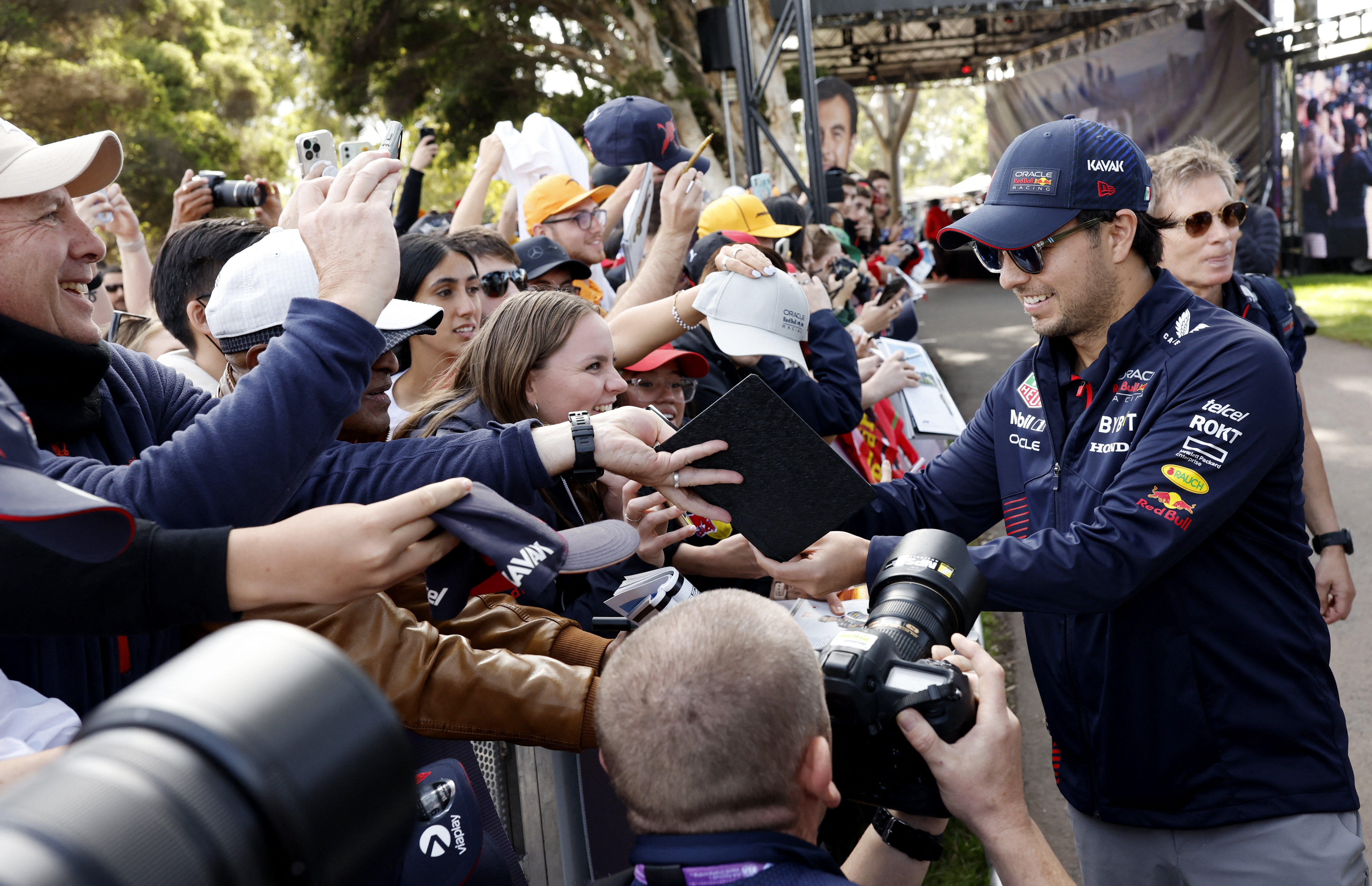 Formula One F1 - Australian Grand Prix - Melbourne Grand Prix Circuit, Melbourne, Australia - March 31, 2023 Red Bull's Sergio Perez with fans arriving at the Melbourne Grand Prix Circuit REUTERS/Darrian Traynor