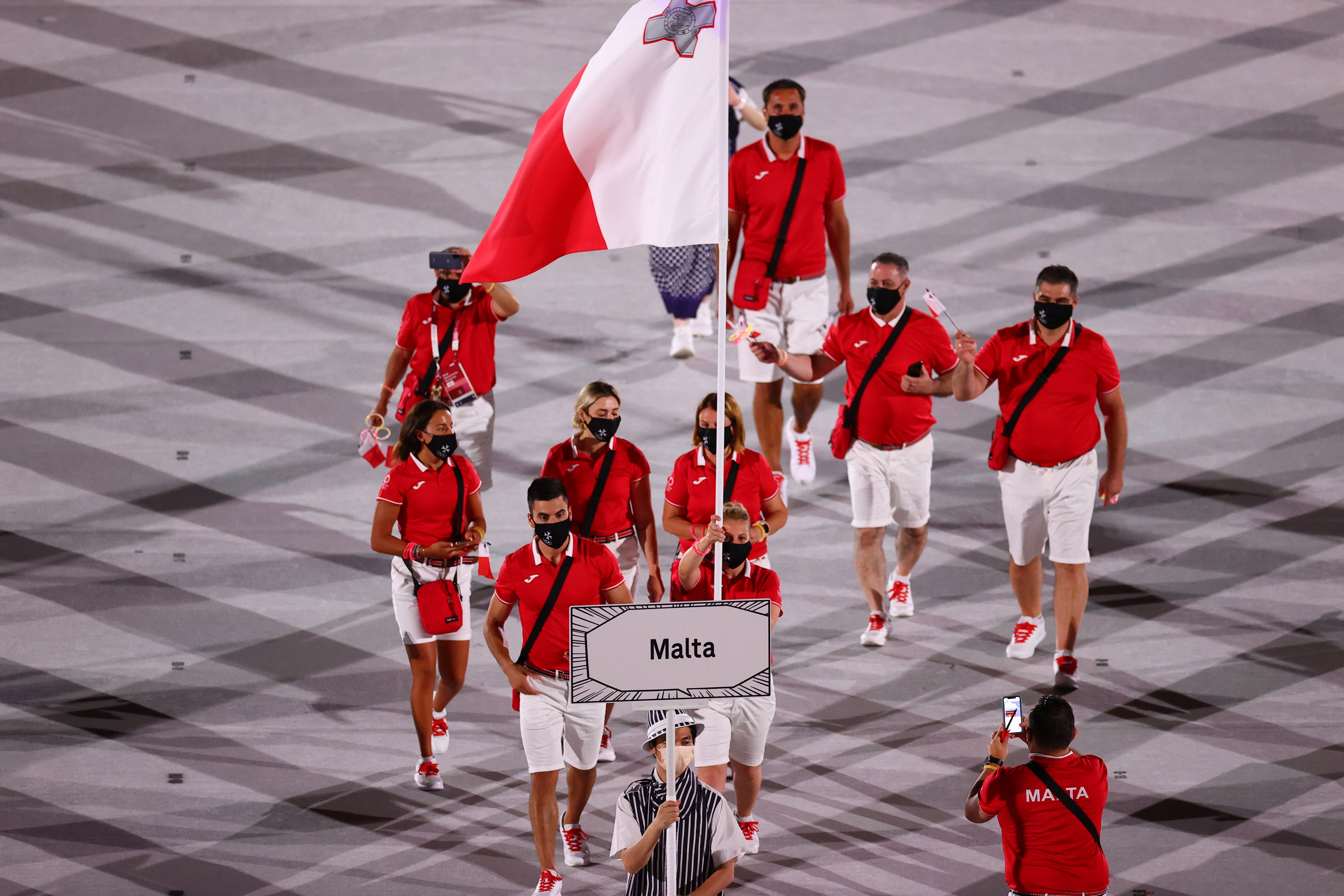 Tokyo 2020 Olympics - The Tokyo 2020 Olympics Opening Ceremony - Olympic Stadium, Tokyo, Japan - July 23, 2021. Flag bearers Andrew Chetcuti of Malta and Eleanor Bezzina of Malta lead their contingent during the athletes parade at the opening ceremony REUTERS/Mike Blake