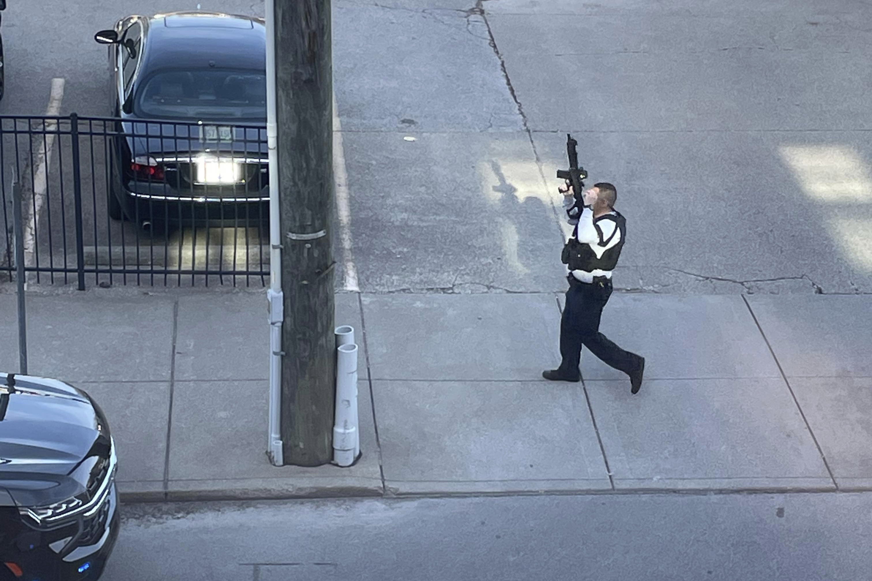 A police officer goes to the scene of a shooting in Louisville, Kentucky, on April 10, 2023. (Reid Cornell via AP)
