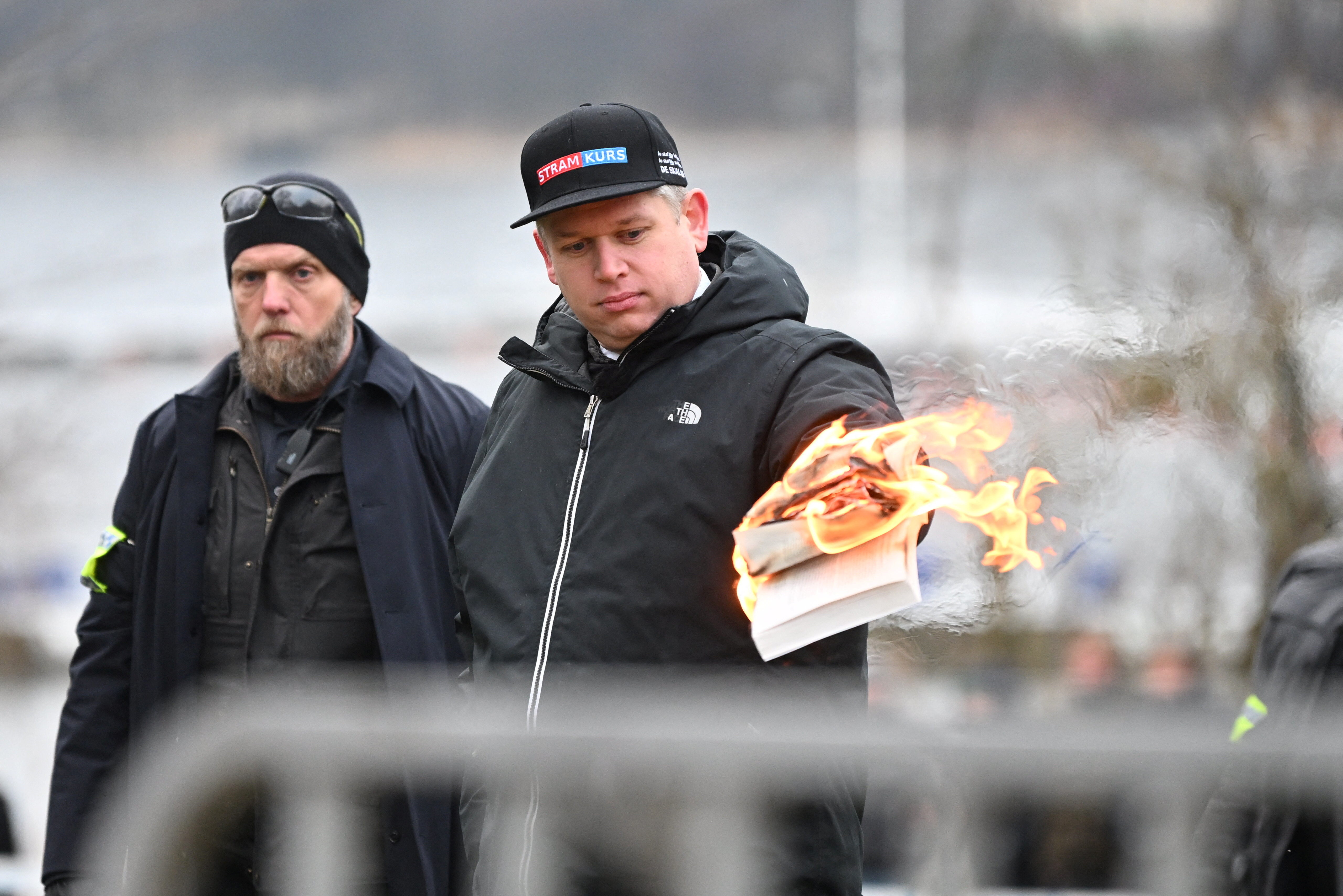 Far-right Danish-Swedish politician Rasmus Paludan set fire to a copy of the Koran outside the Turkish embassy in the Swedish capital on Saturday, (Fredrik Sandberg/TT News Agency/via REUTERS)