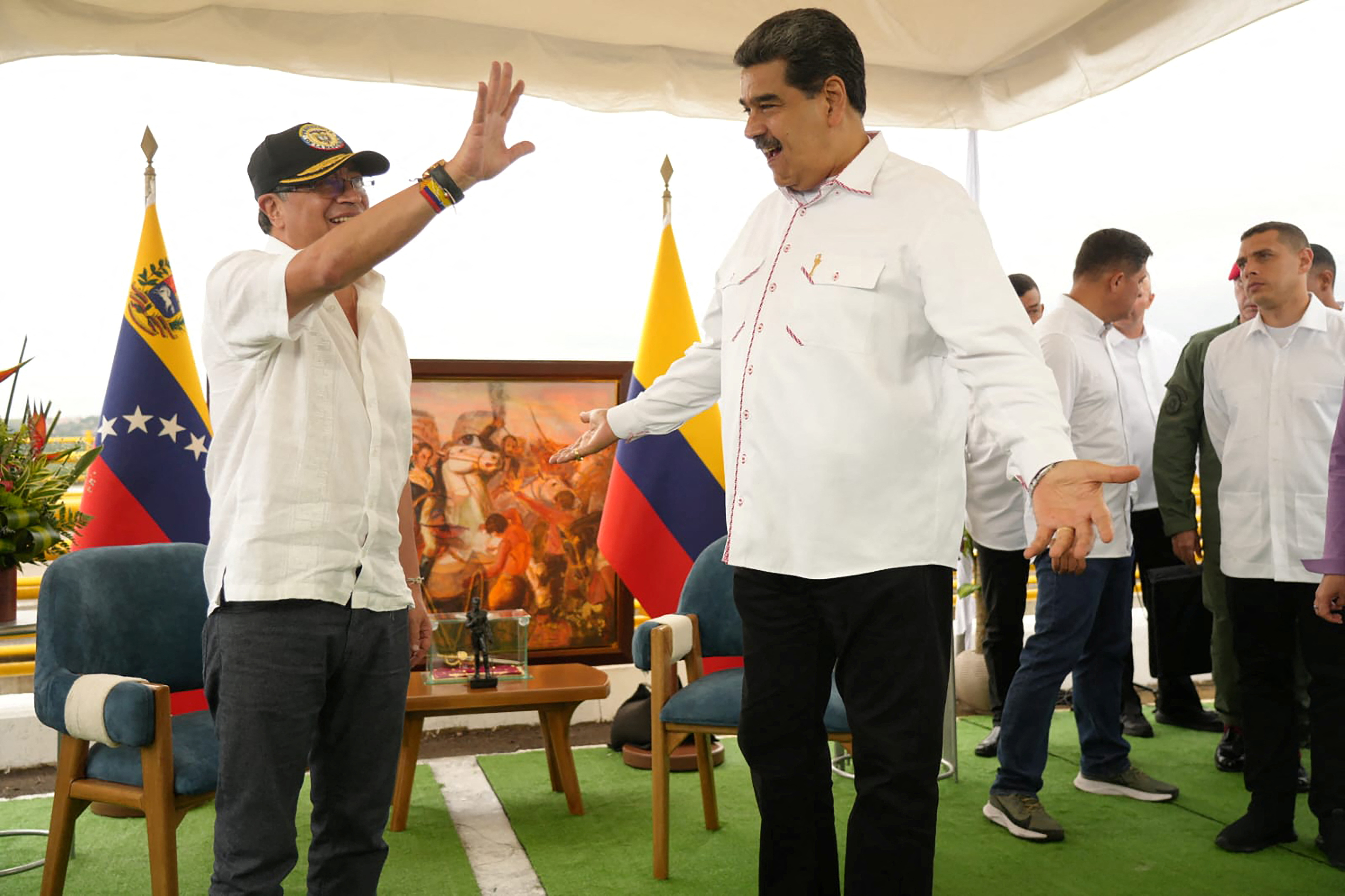 Colombian President Gustavo Petro waves as Venezuelan President Nicolas Maduro reacts during a meeting for signing the Partial Scope Agreement Number 28 that will resume bilateral trade between Colombia and Venezuela at the Atanasio Girardot International Bridge on the border between Colombia and Venezuela, in San Antonio del Tachira, Venezuela, February 16, 2023. Colombian Presidency/Handout via REUTERS ATTENTION EDITORS - THIS IMAGE WAS PROVIDED BY A THIRD PARTY. NO RESALES. NO ARCHIVES. MANDATORY CREDIT.