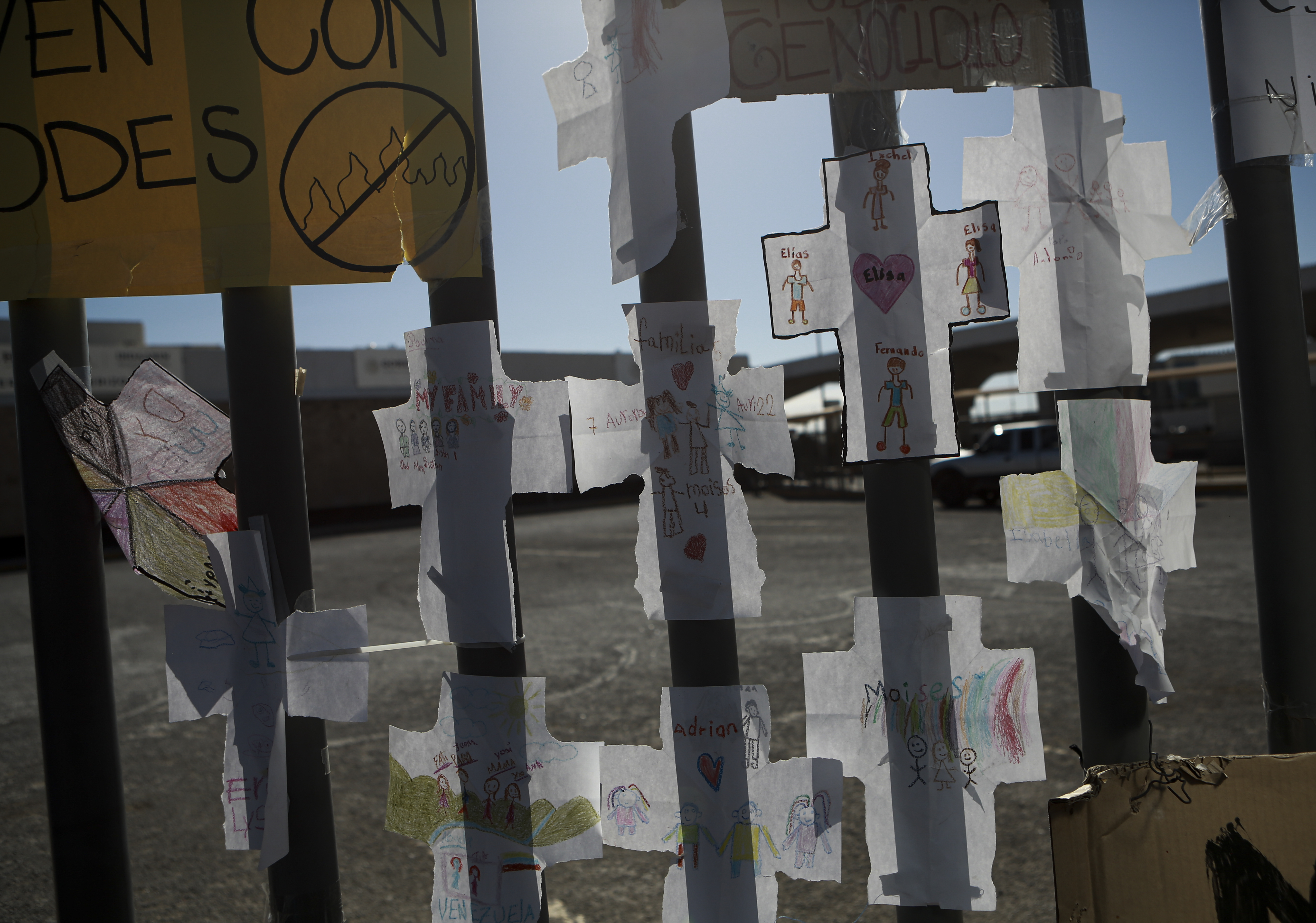 Paper crosses with the names of the migrants who died in last month's fire are taped to a fence at the migrant detention center where more than three dozen people died from a fire that started in one of the cells, in Ciudad Juárez, Mexico, on Thursday, April 20, 2023. (AP Photo/Christian Chávez)