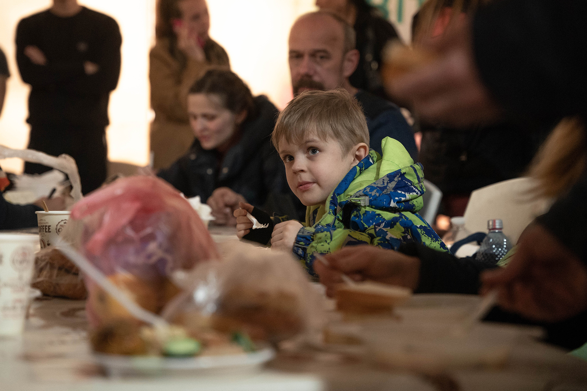 Un joven recibe un plato de comida al arribar al centro de contención y asistencia de la ciudad de Zaporizhzhia.