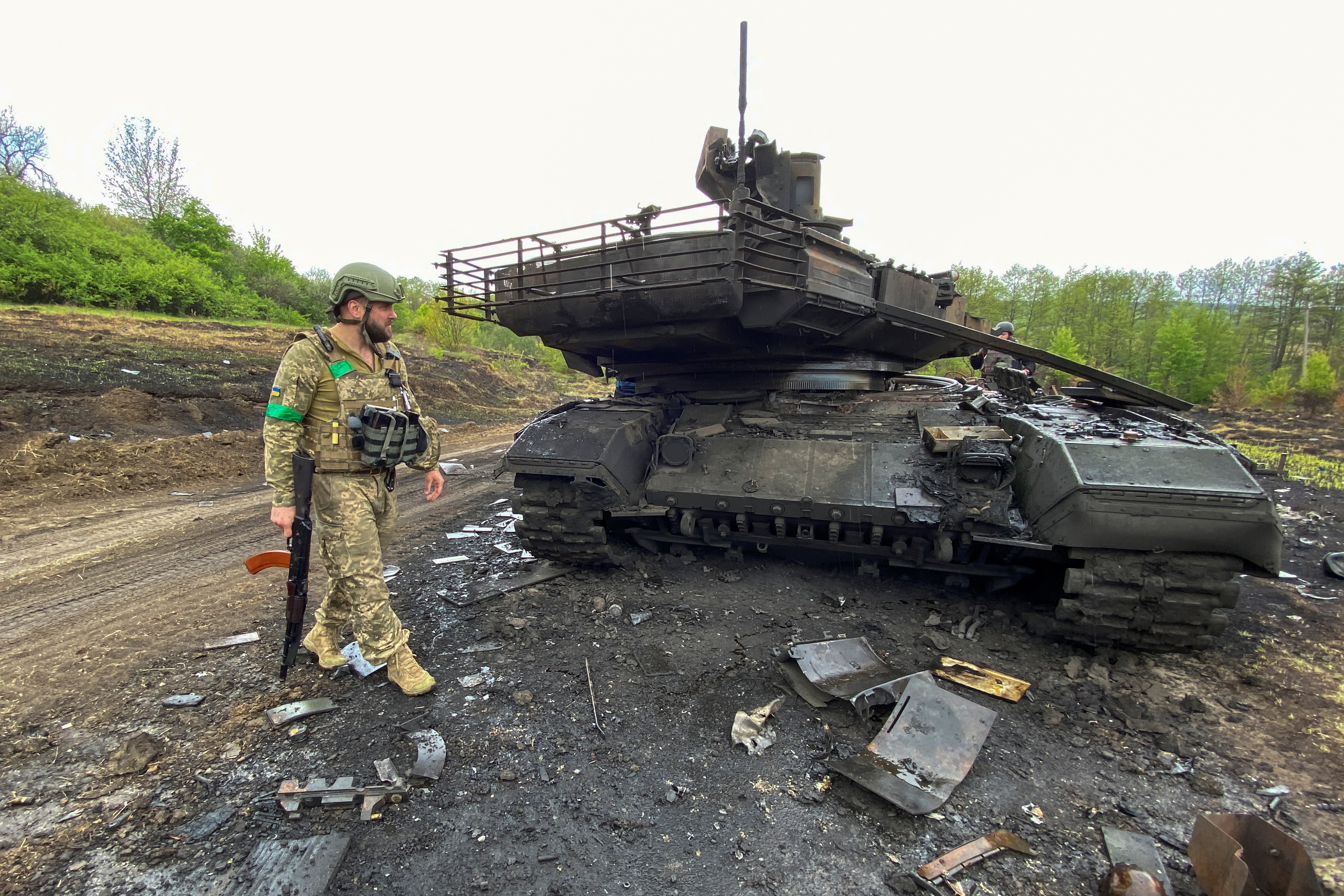 Ukrainian serviceman walks next to a destroyed Russian main battle tank T-90M Proryv, as Russia's attack on Ukraine continues, near the village of Staryi Saltiv in Kharkiv region, Ukraine May 9, 2022. Picture taken May 9, 2022. REUTERS/Vitalii Hnidyi
