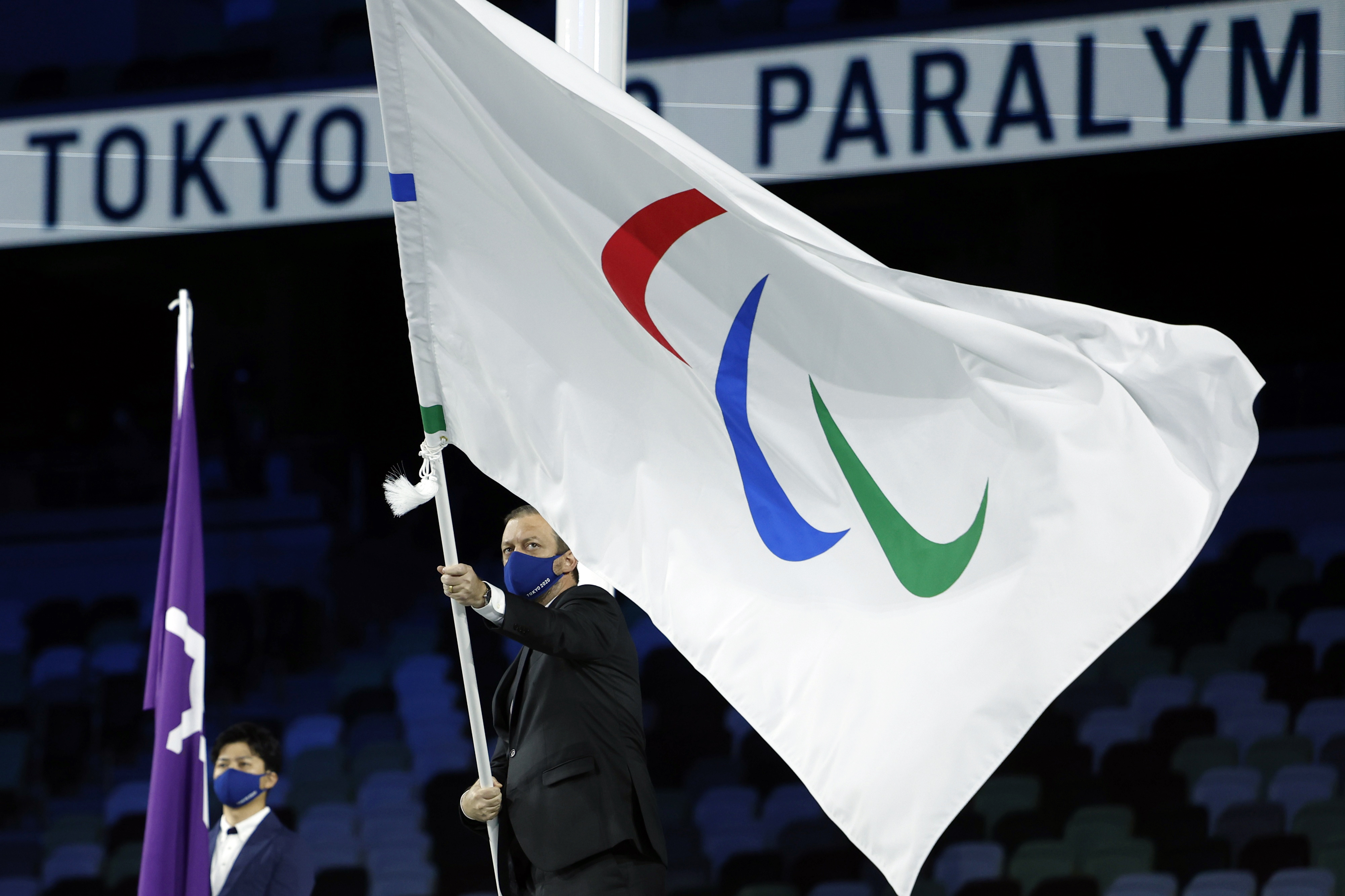 Tokyo 2020 Paralympic Games - The Tokyo 2020 Paralympic Games Closing Ceremony - Olympic Stadium, Tokyo, Japan - September 5, 2021. The International Paralympic Committee President Andrew Parsons waves the Paralympic flag during the closing ceremony REUTERS/Issei Kato