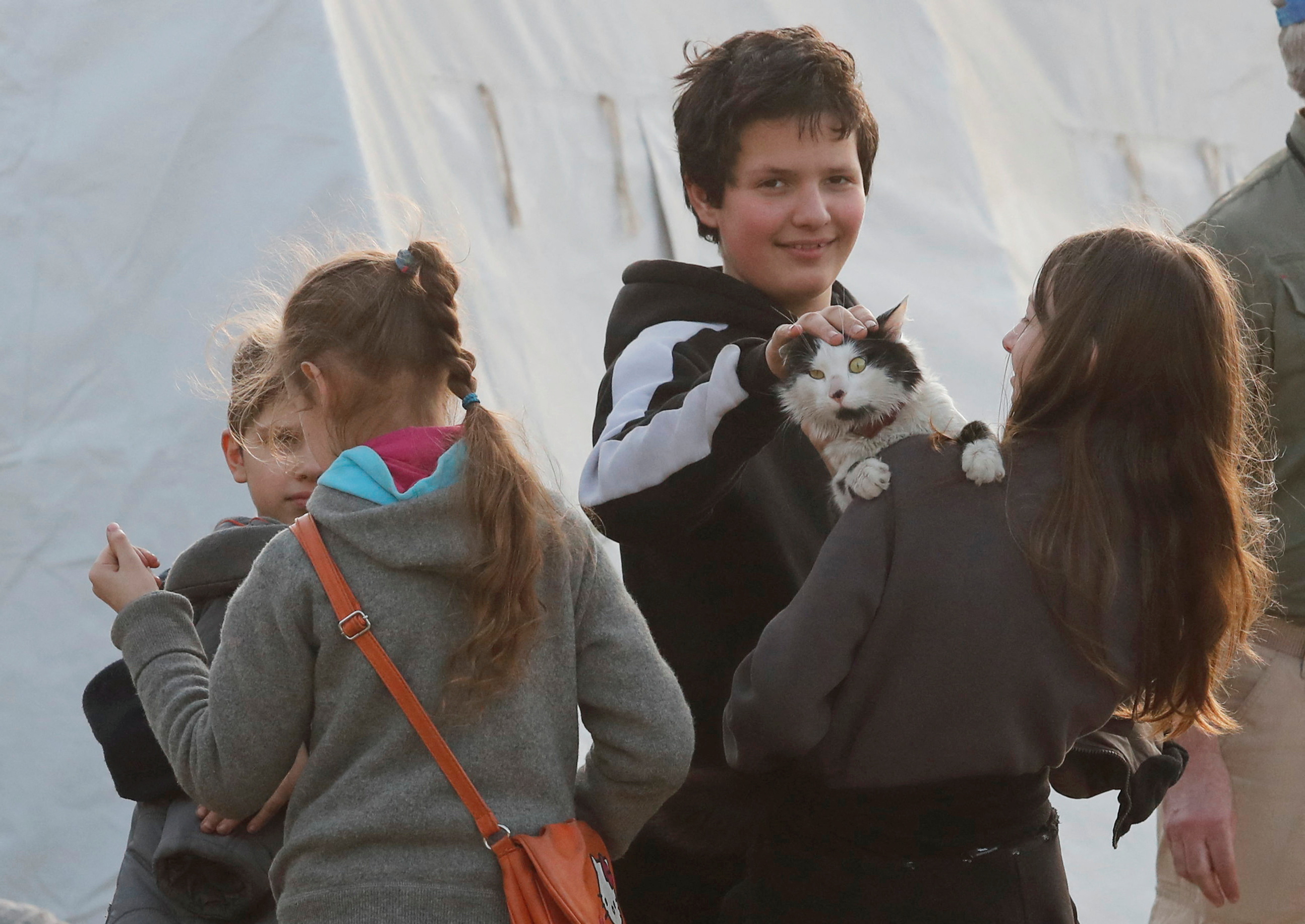 Niños con un gato en un centro de alojamiento temporal para los evacuados durante el conflicto entre Ucrania y Rusia en el pueblo de Bezimenne en la región de Donetsk, Ucrania 1 de mayo de 2022. REUTERS/Alexander Ermochenko