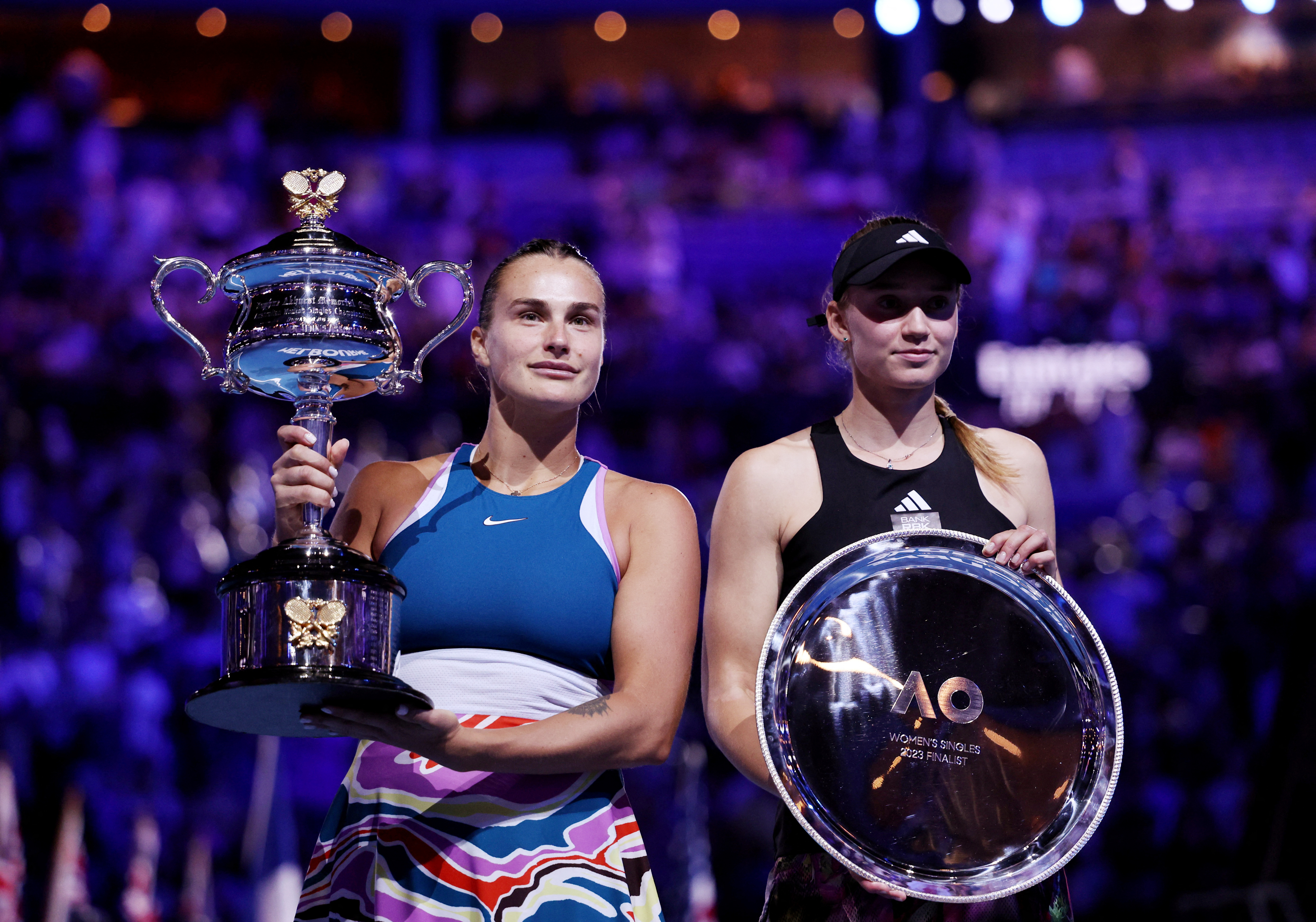 Aryna Sabalenka poses with the Australian Open champion trophy with her rival Elena Rybakina (REUTERS/Loren Elliott)